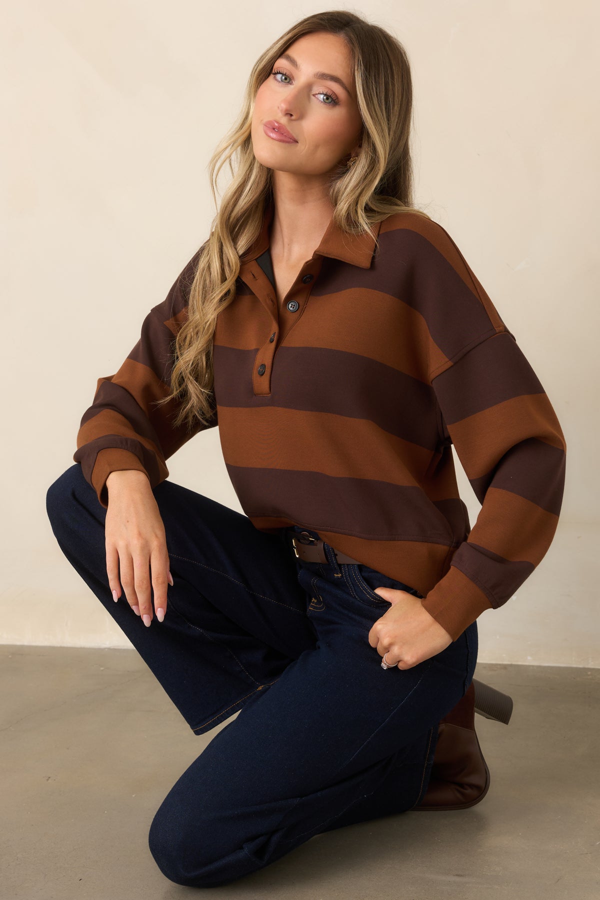 Close view of the caramel and deep brown wide stripes, pointed collar, and button placket.