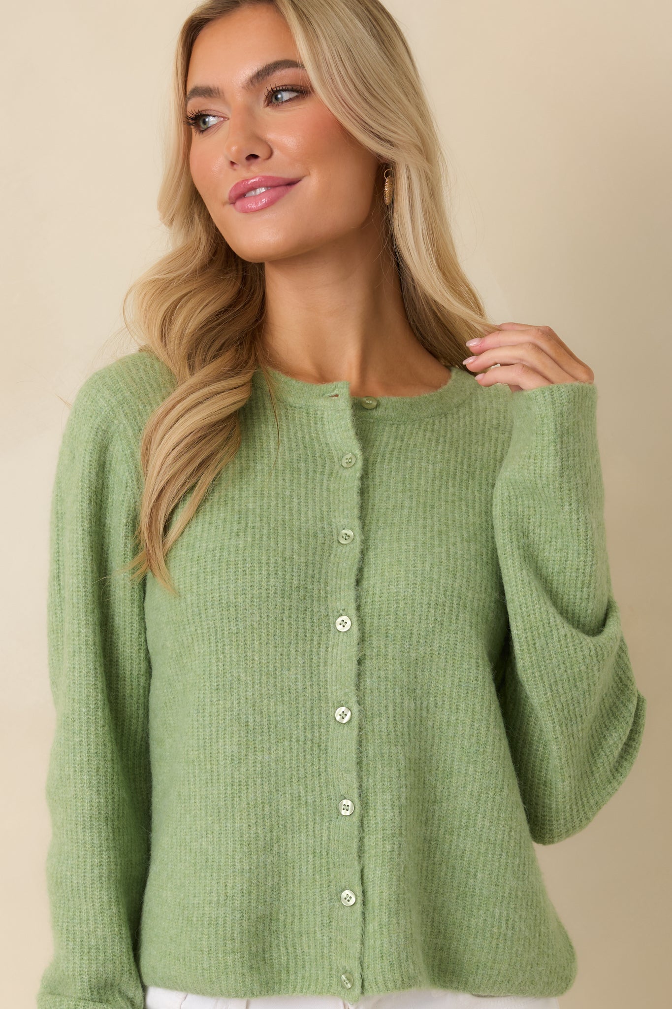 Close-up on front of cardigan showing button closure and lightweight ribbed texture.