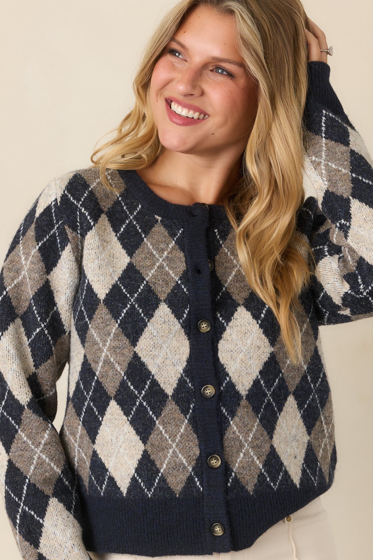 Cardigan detail featuring the ribbed crew neckline, navy trim, and contrasting diamond knit pattern.