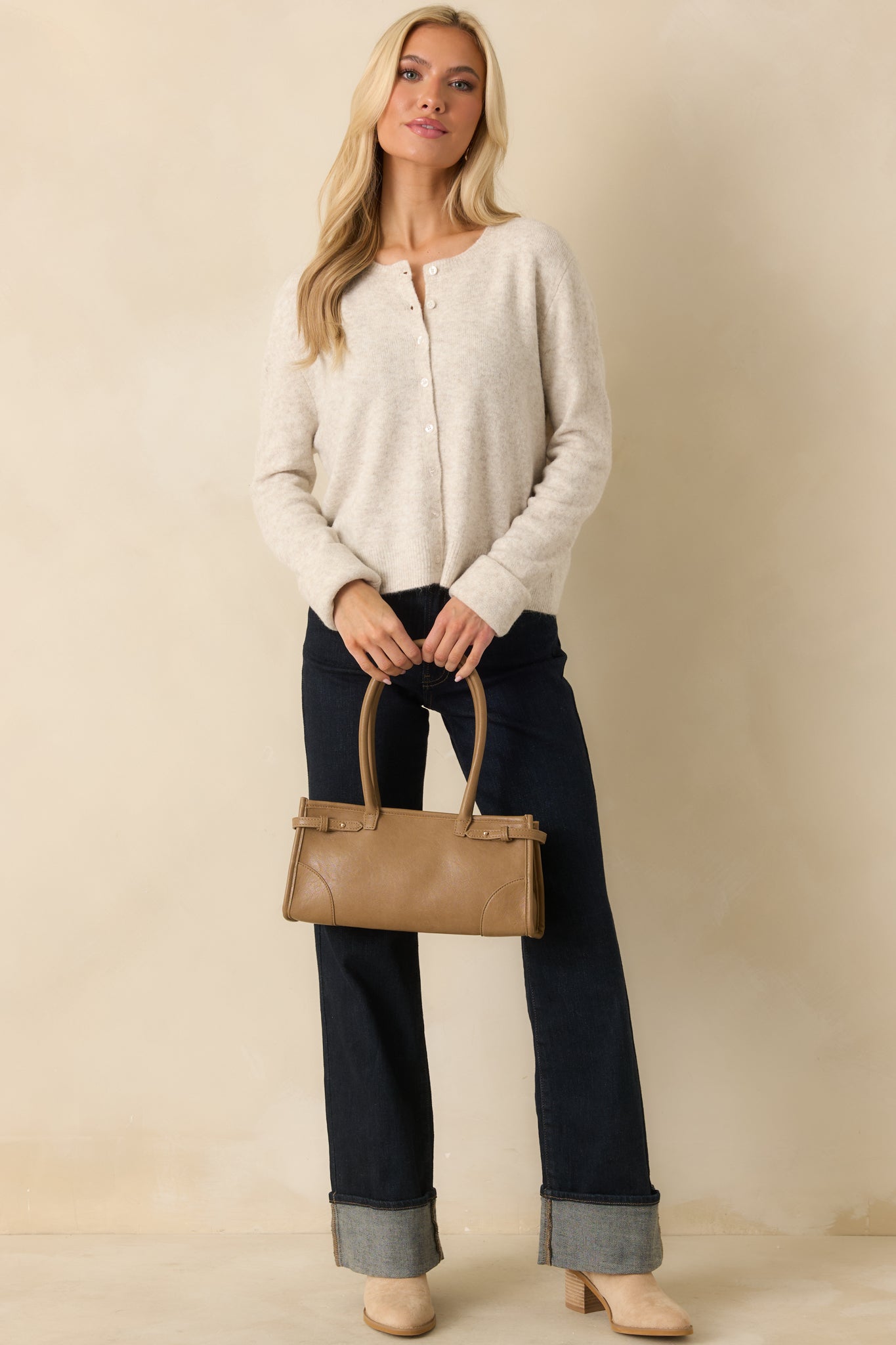 Cardigan displaying ribbed cuffs and hem with cozy knit texture.