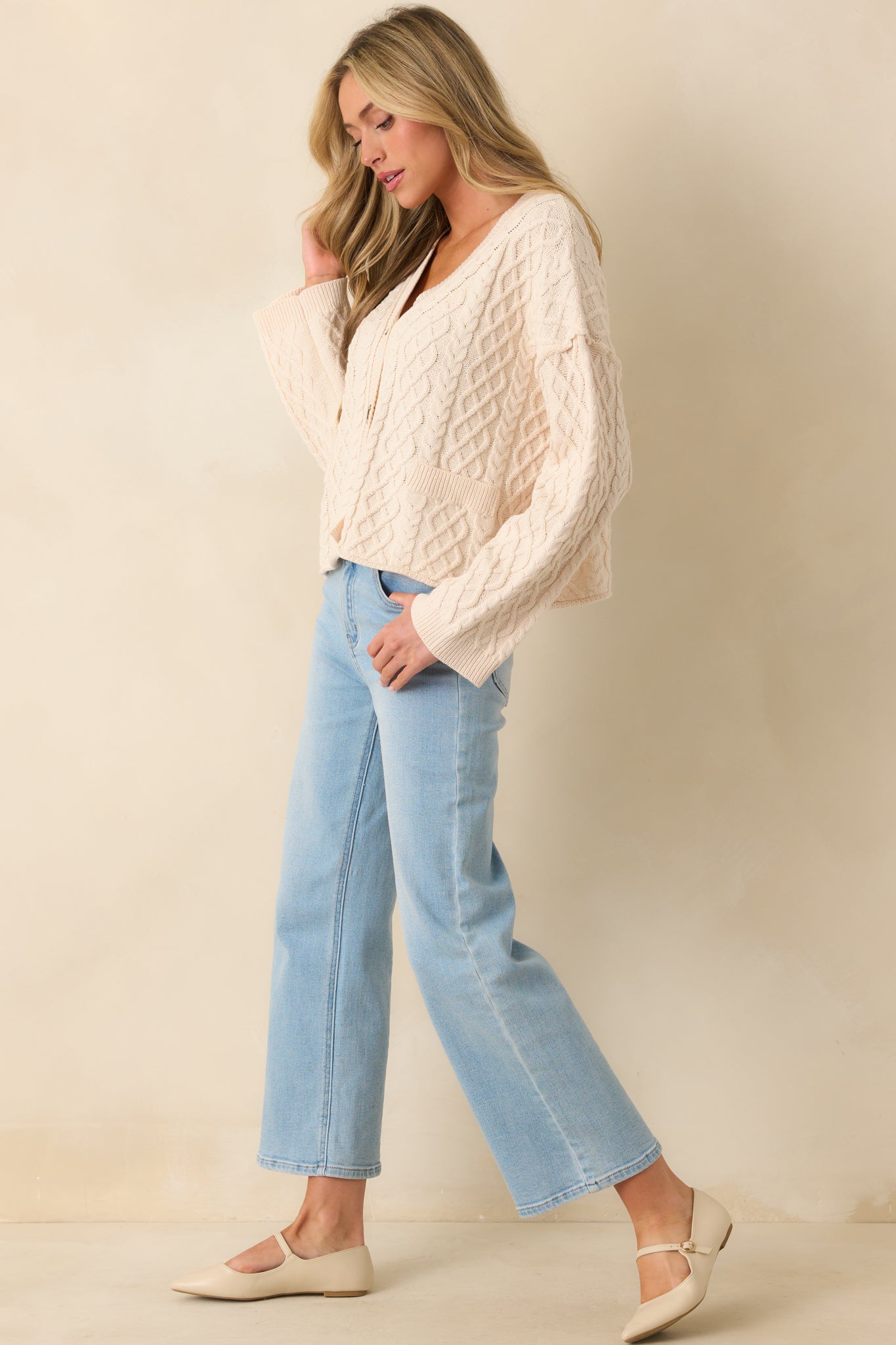 Cardigan styled to showcase the ribbed hems and faux front patch pockets.