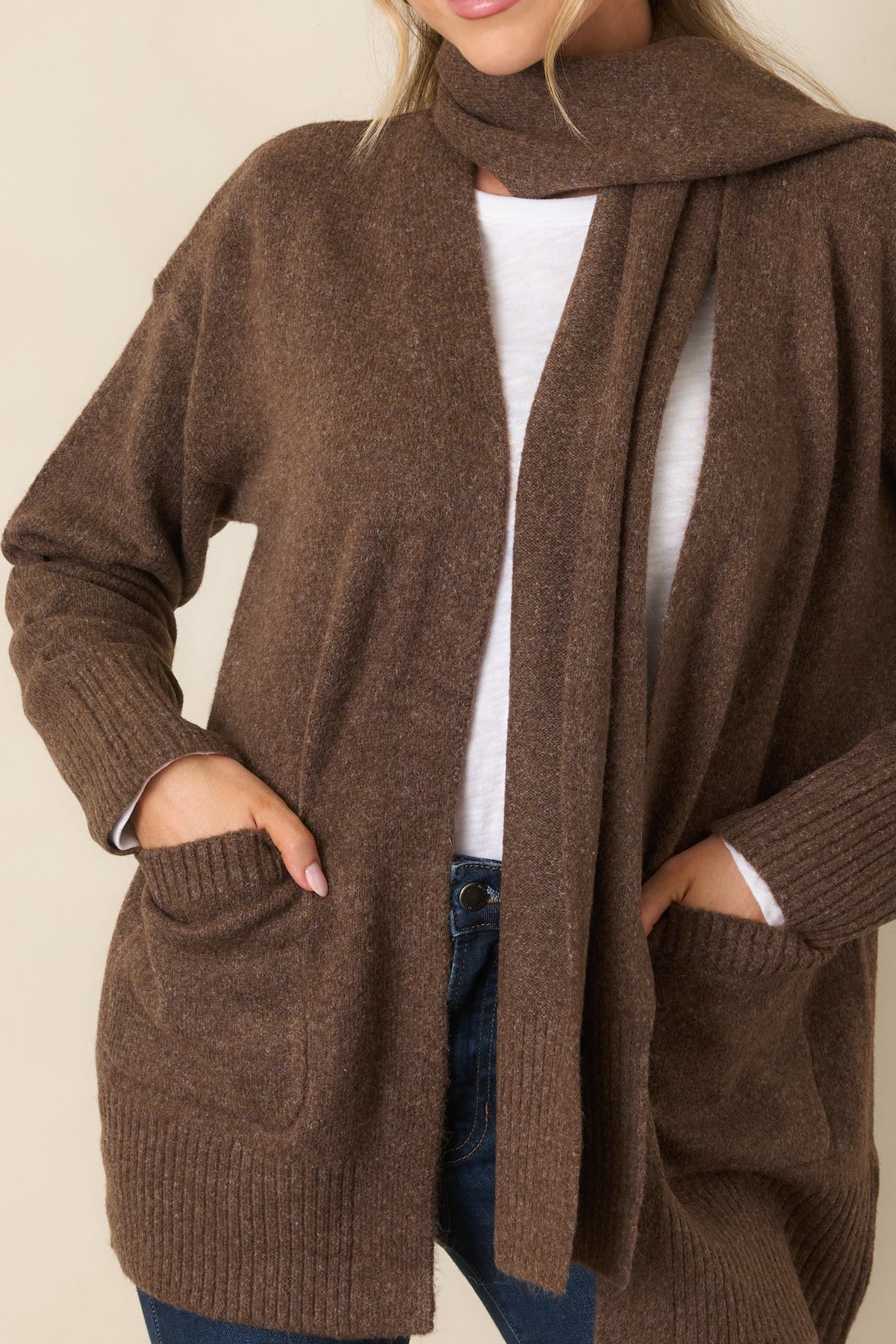 Close view of the cardigan’s textured ribbed trim and practical front patch pocket.