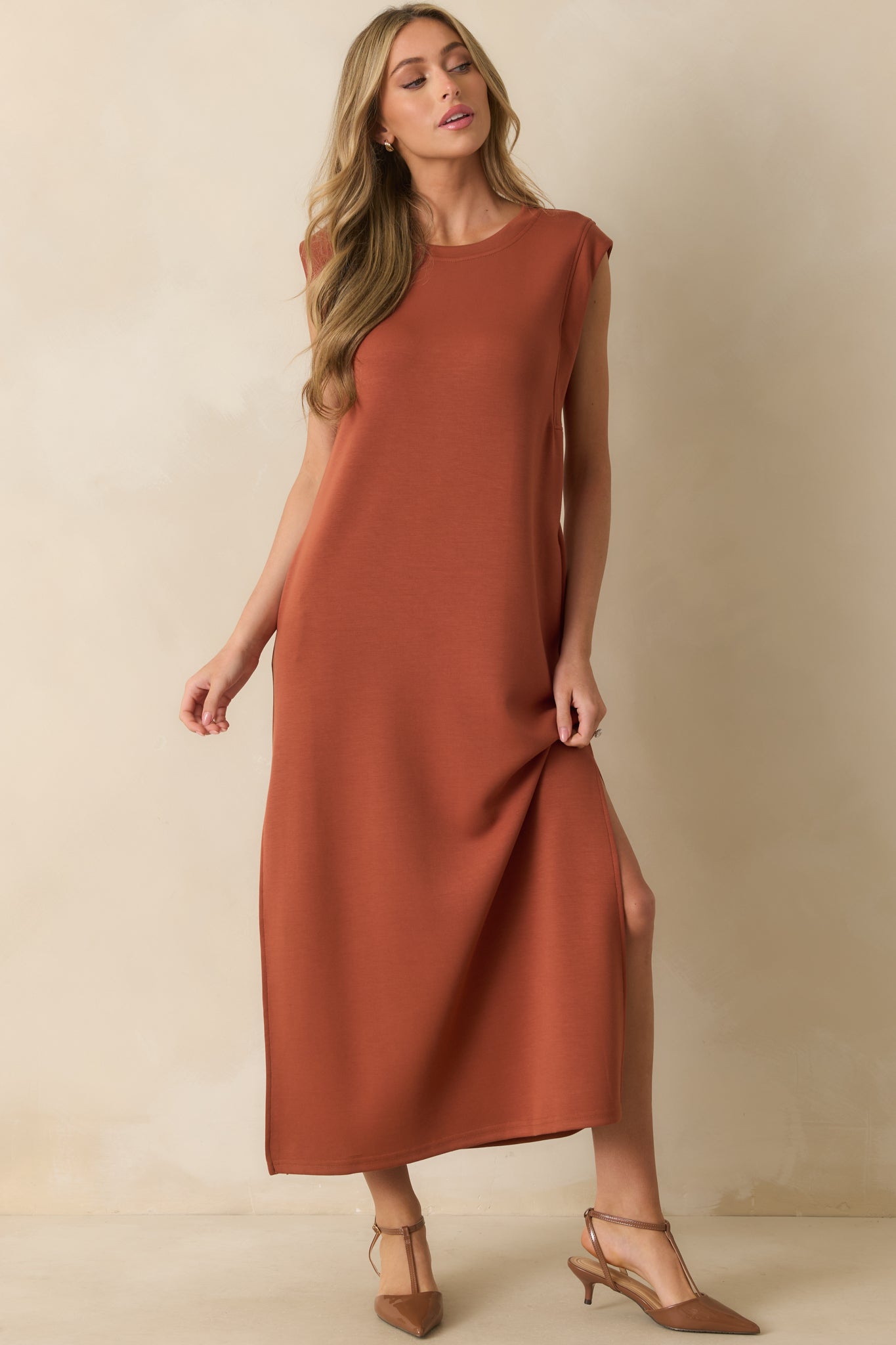 Casual maxi dress in warm orange tone with short cap sleeves, roomy pockets, and lightweight drape.