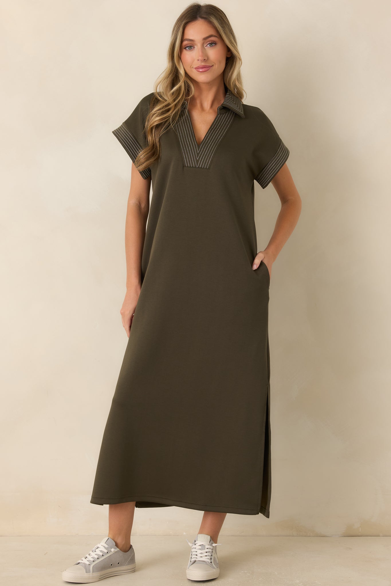 Casual olive maxi dress with a V-neck collar, relaxed construction, and sporty-inspired striped trim for a polished finish.