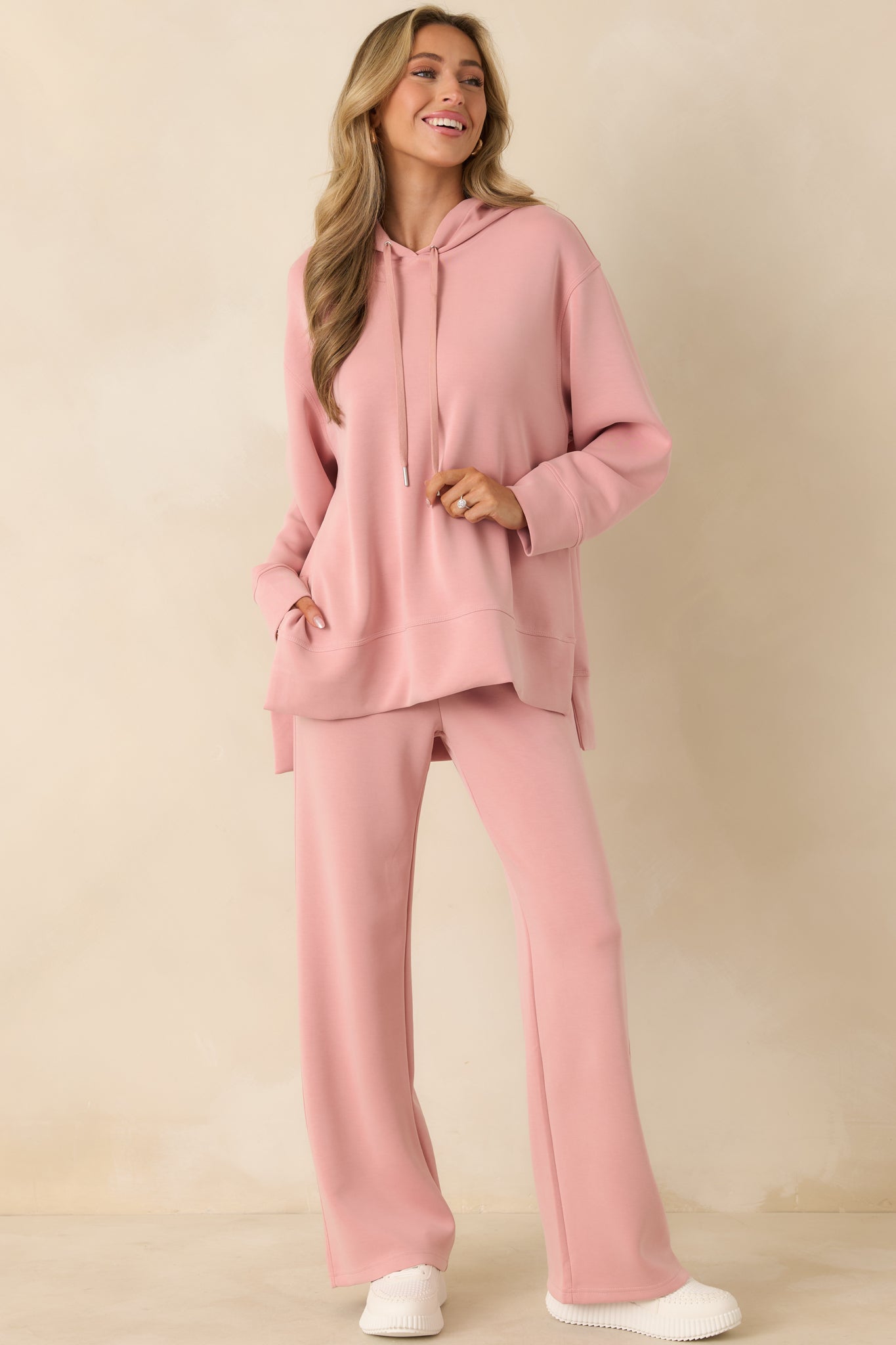 Casual pink pullover hoodie with ribbed cuffs and relaxed silhouette.