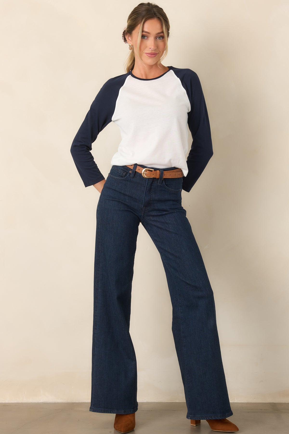 Chalk white polyester-cotton top with contrasting navy raglan sleeves and relaxed fit.