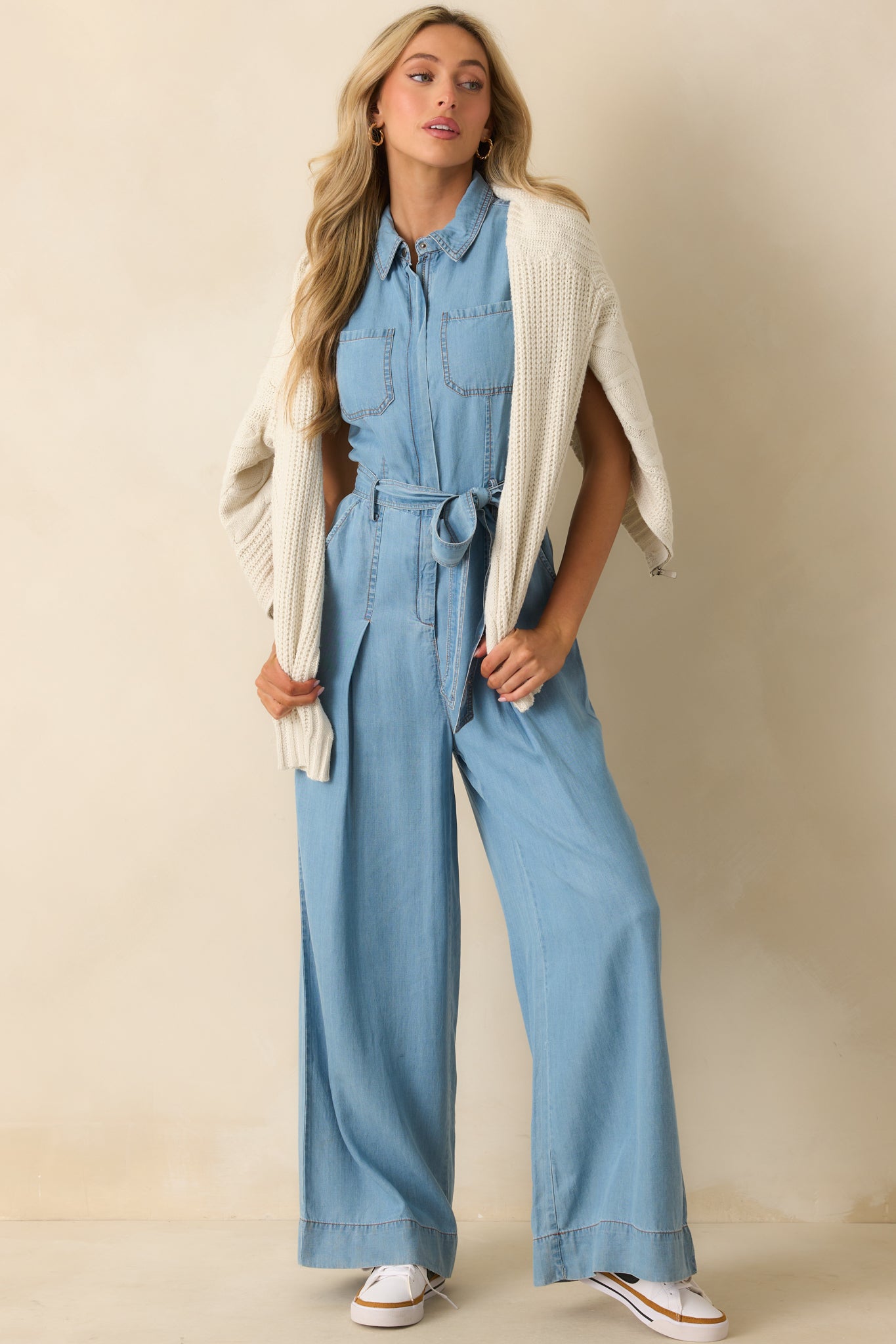 Chambray jumpsuit with sleeveless design, collared neckline, functional zip front, and wide-leg pants with belt loops.