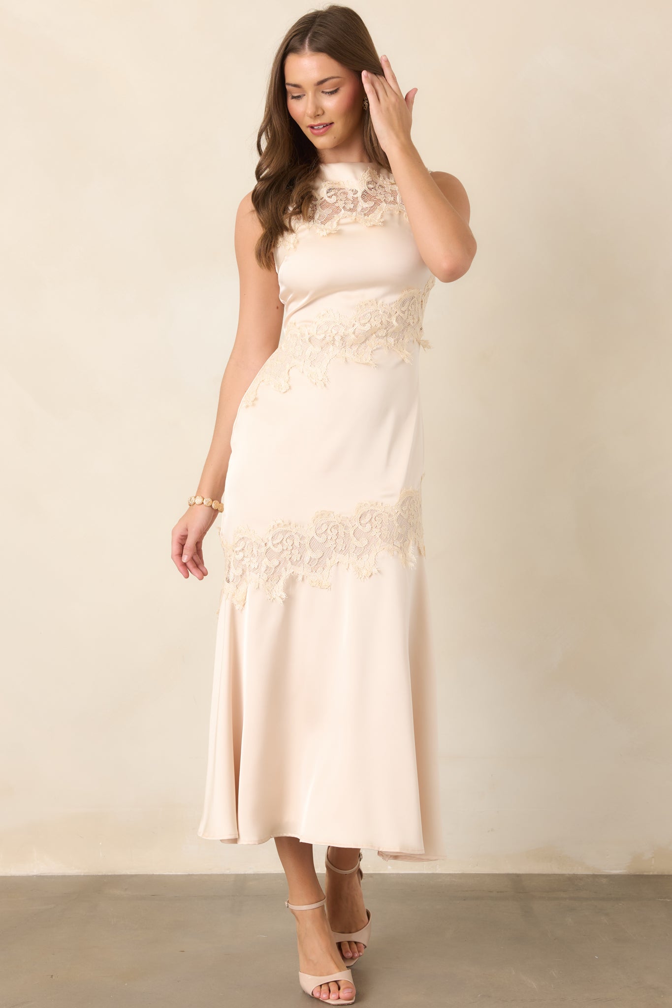 Sleek champagne satin dress featuring tonal lace along the neckline and waist with a gently flowing midi skirt.