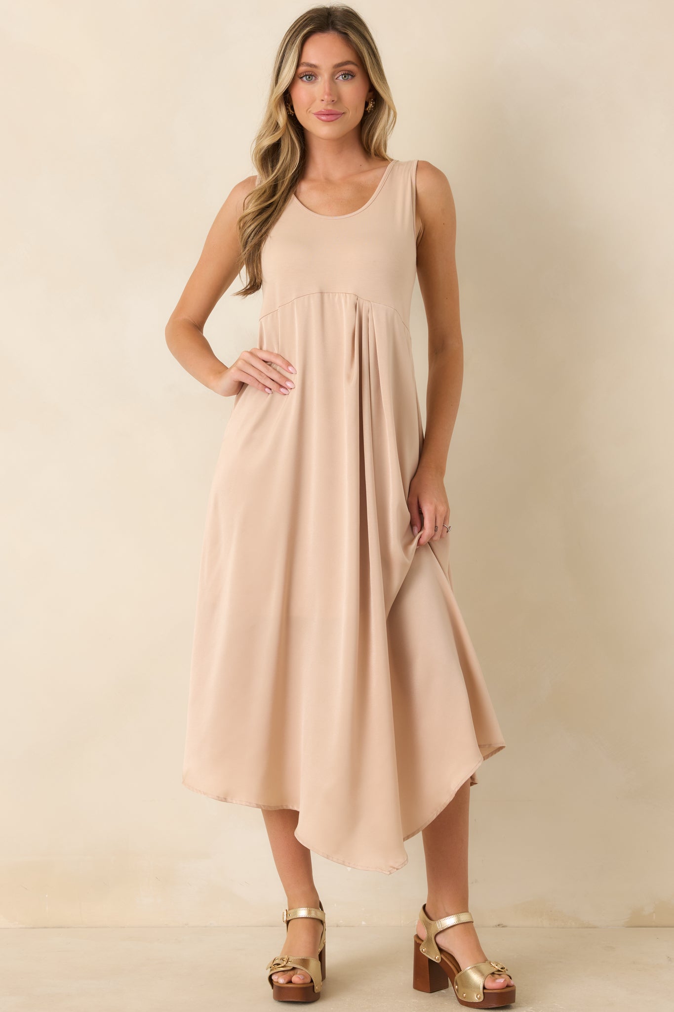 Front view highlighting the scoop neckline, fitted stretch-knit bodice, and flowing satin midi skirt in a soft champagne hue.