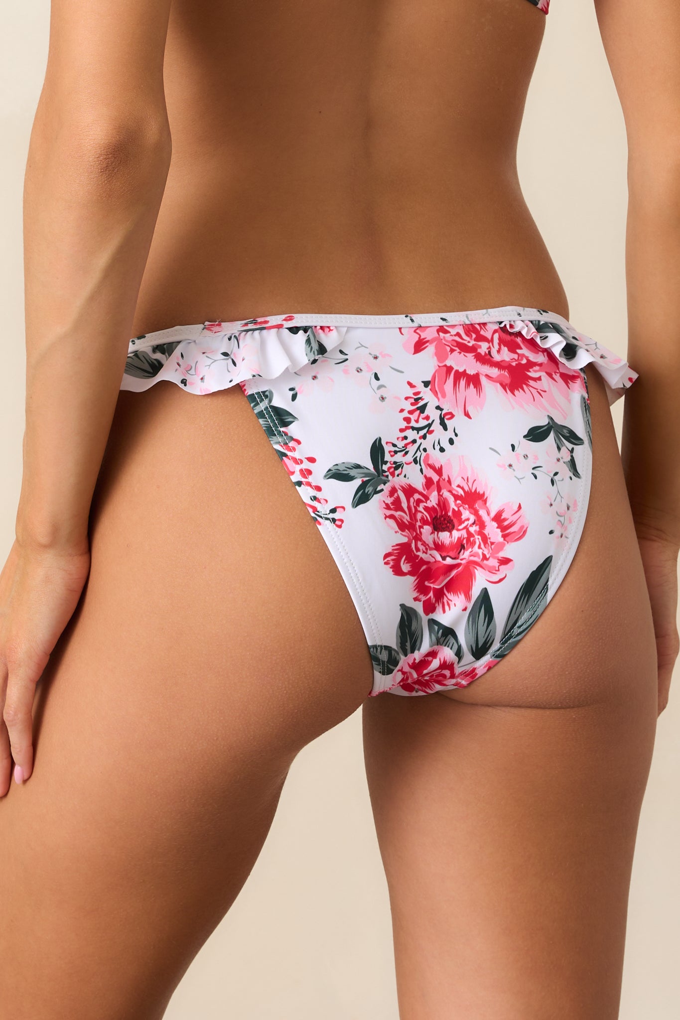 A cheeky rear design with soft ruffle accents, blending wild cheetah spots and delicate florals in a bold pink hue.