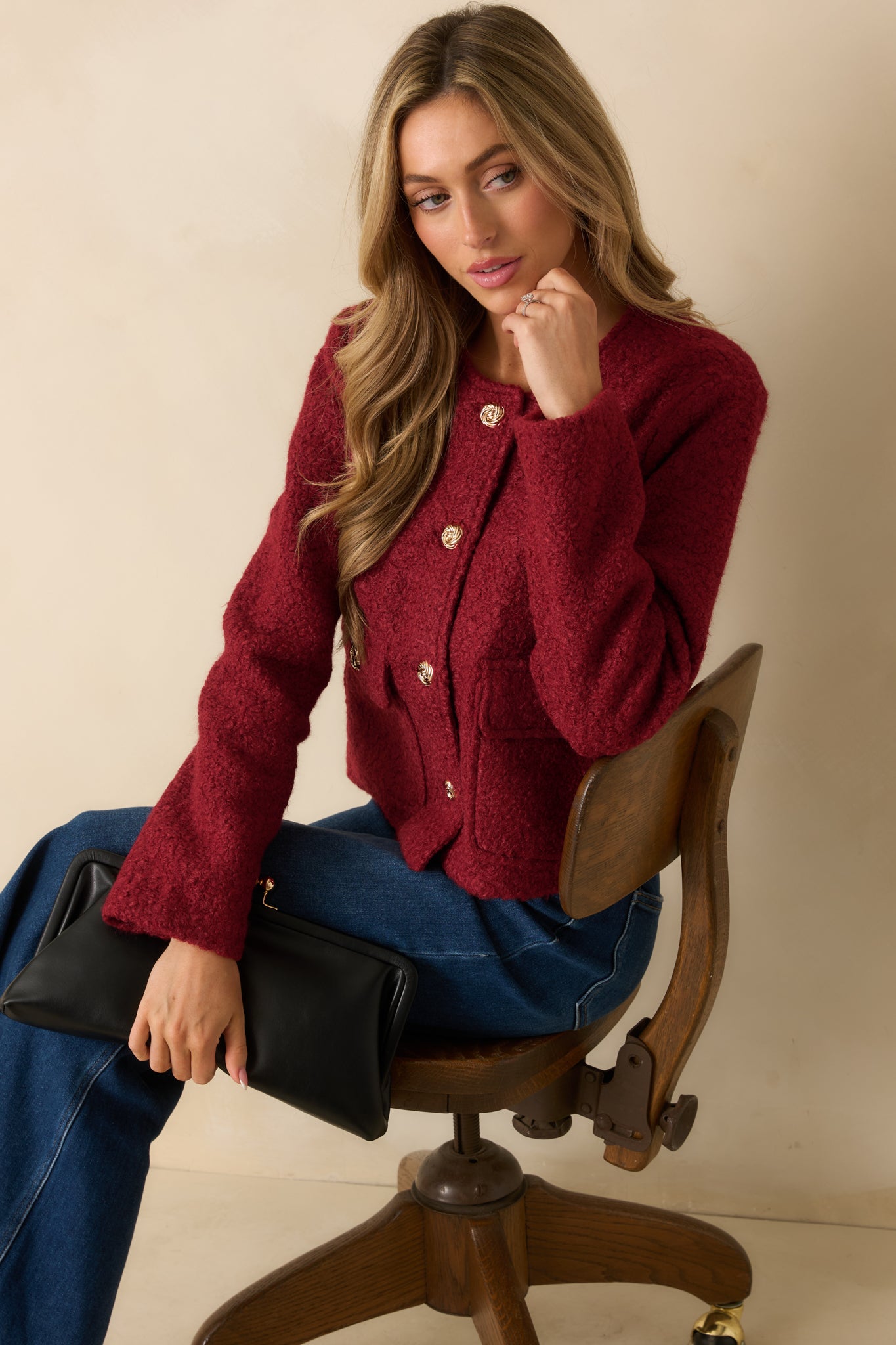 Cherry red bouclé jacket with a classic round neckline, long sleeves, front flap pockets, and elegant gold buttons for a polished look.