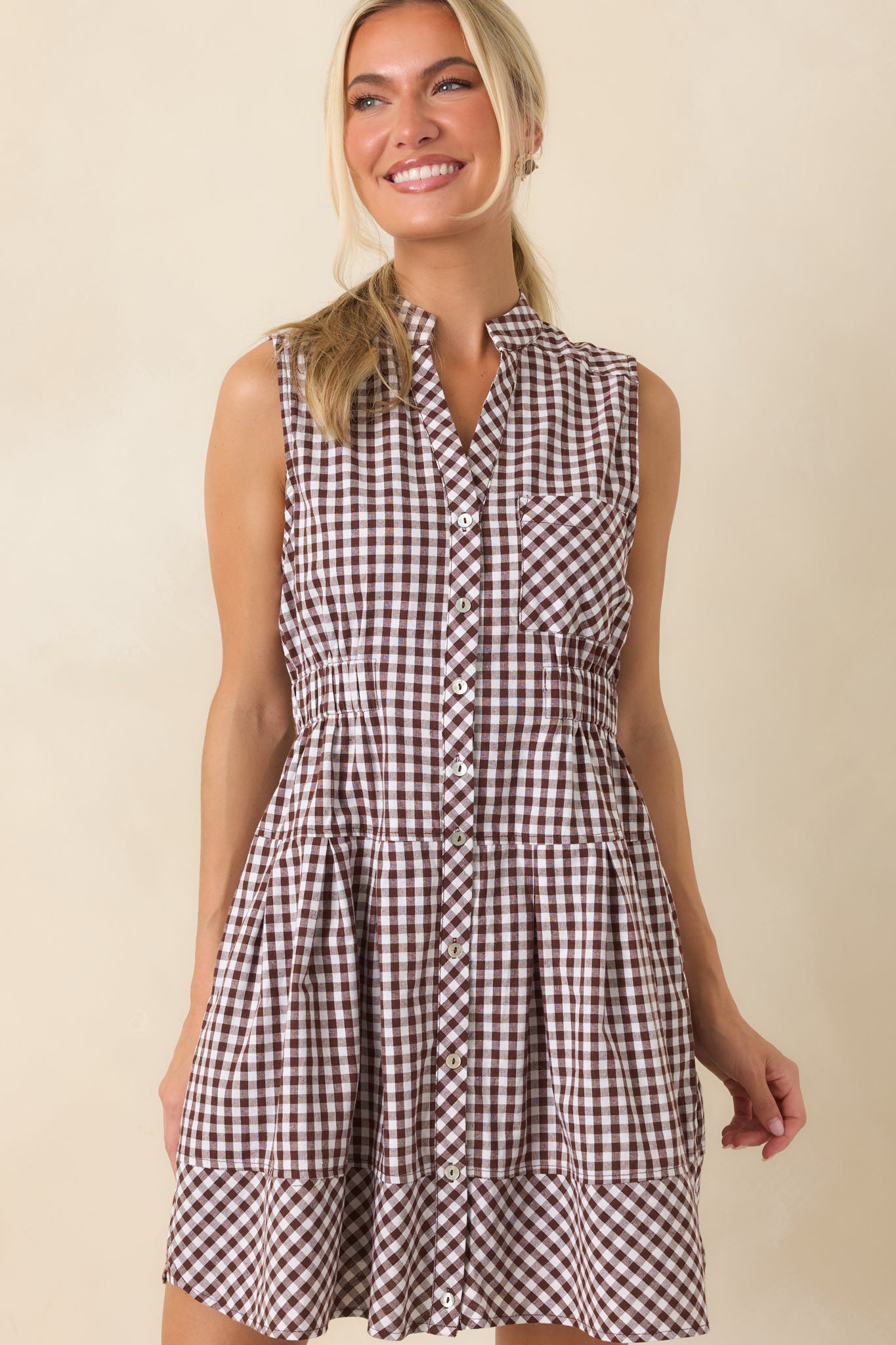 Chest pocket adds a tailored detail to the relaxed silhouette of this gingham mini dress.