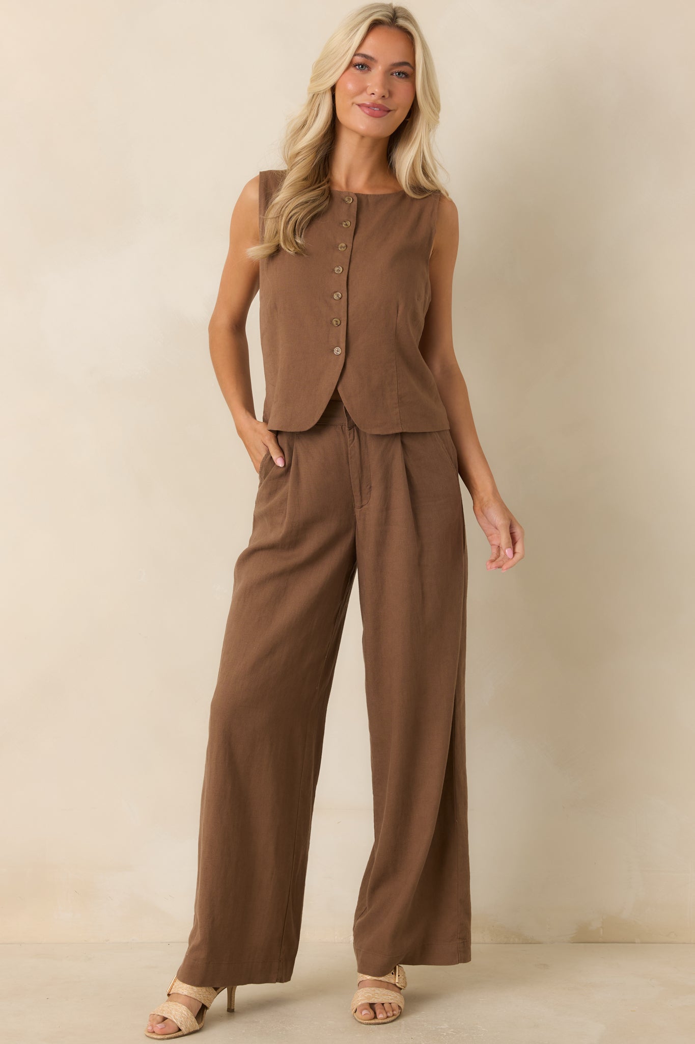Chestnut brown sleeveless vest featuring a rounded neckline, button-front closure, and slightly fitted silhouette.
