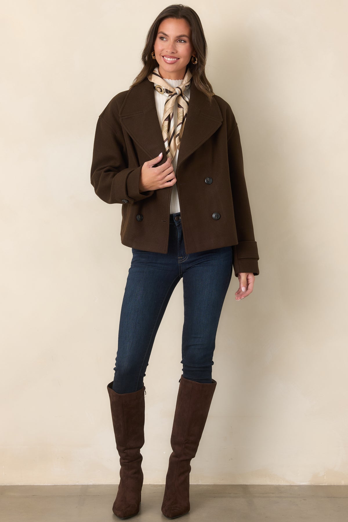Chocolate brown jacket with dropped shoulders, long sleeves, and a relaxed boxy silhouette.
