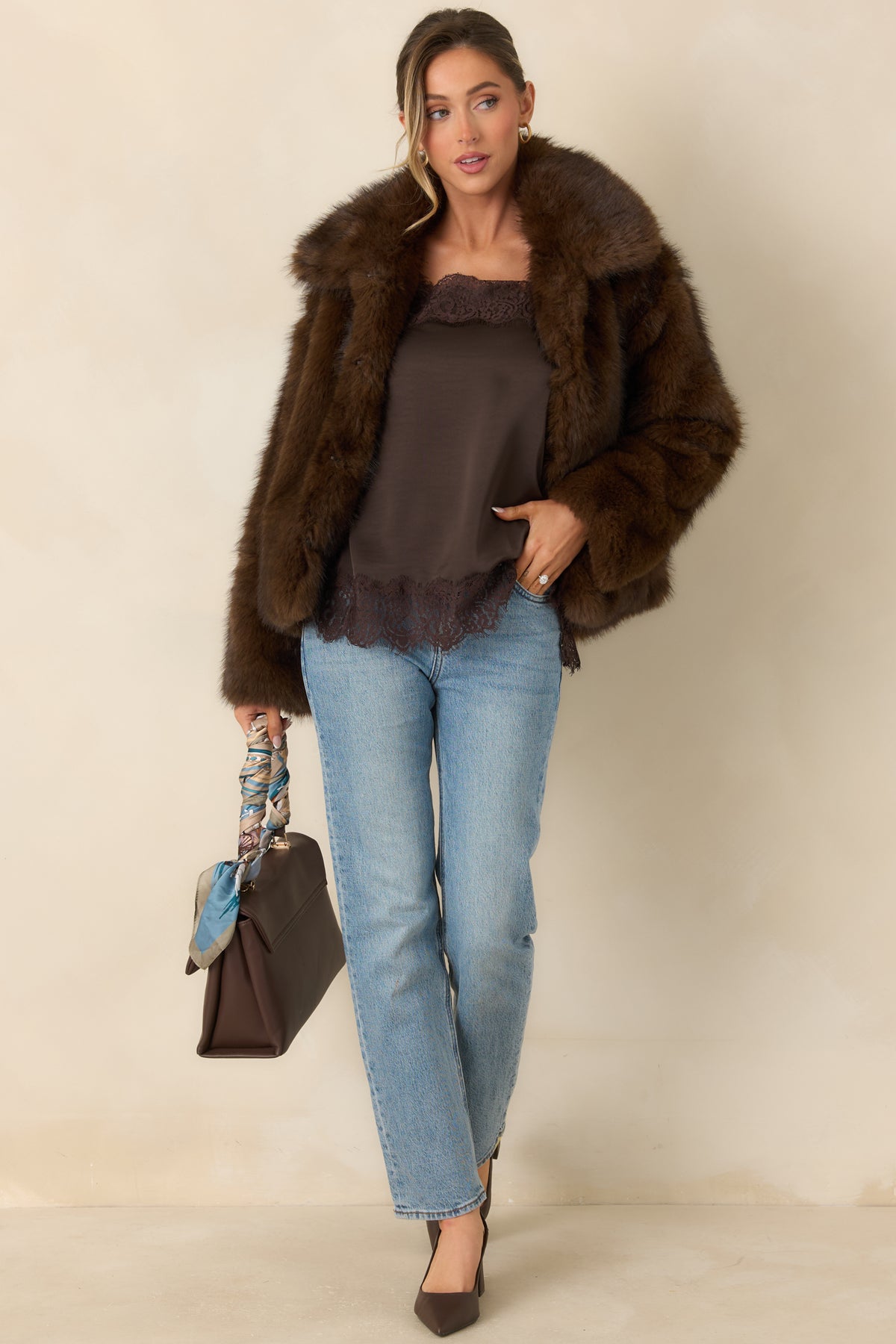 Chocolate brown faux fur jacket with a generous collar, long sleeves, and a relaxed silhouette.