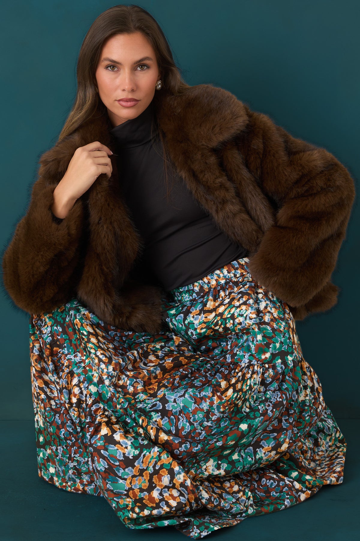 Plush chocolate brown faux fur jacket featuring a generous collar, long sleeves, and relaxed silhouette.