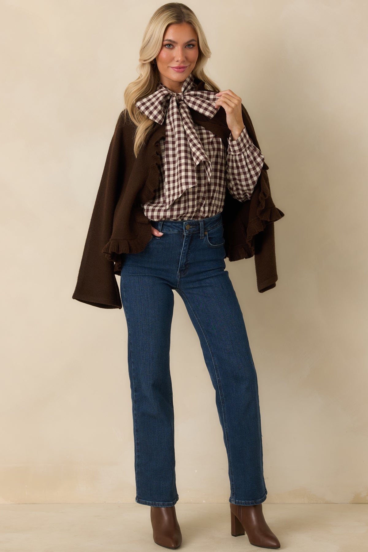 Chocolate brown gingham blouse with a removable oversized neck tie, relaxed fit, and buttoned sleeve cuffs.