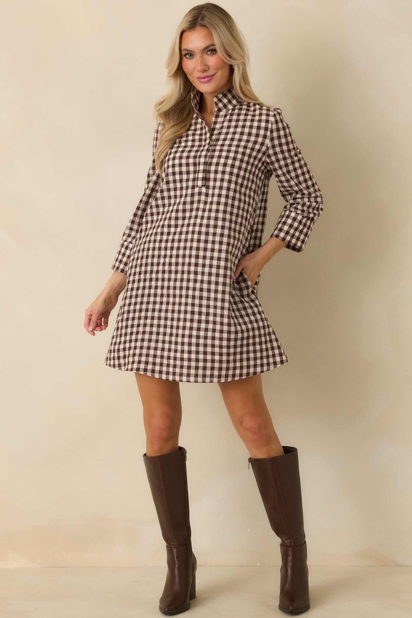 Chocolate brown and ivory gingham mini dress featuring a structured stand collar, three-quarter sleeves, and relaxed A-line silhouette.