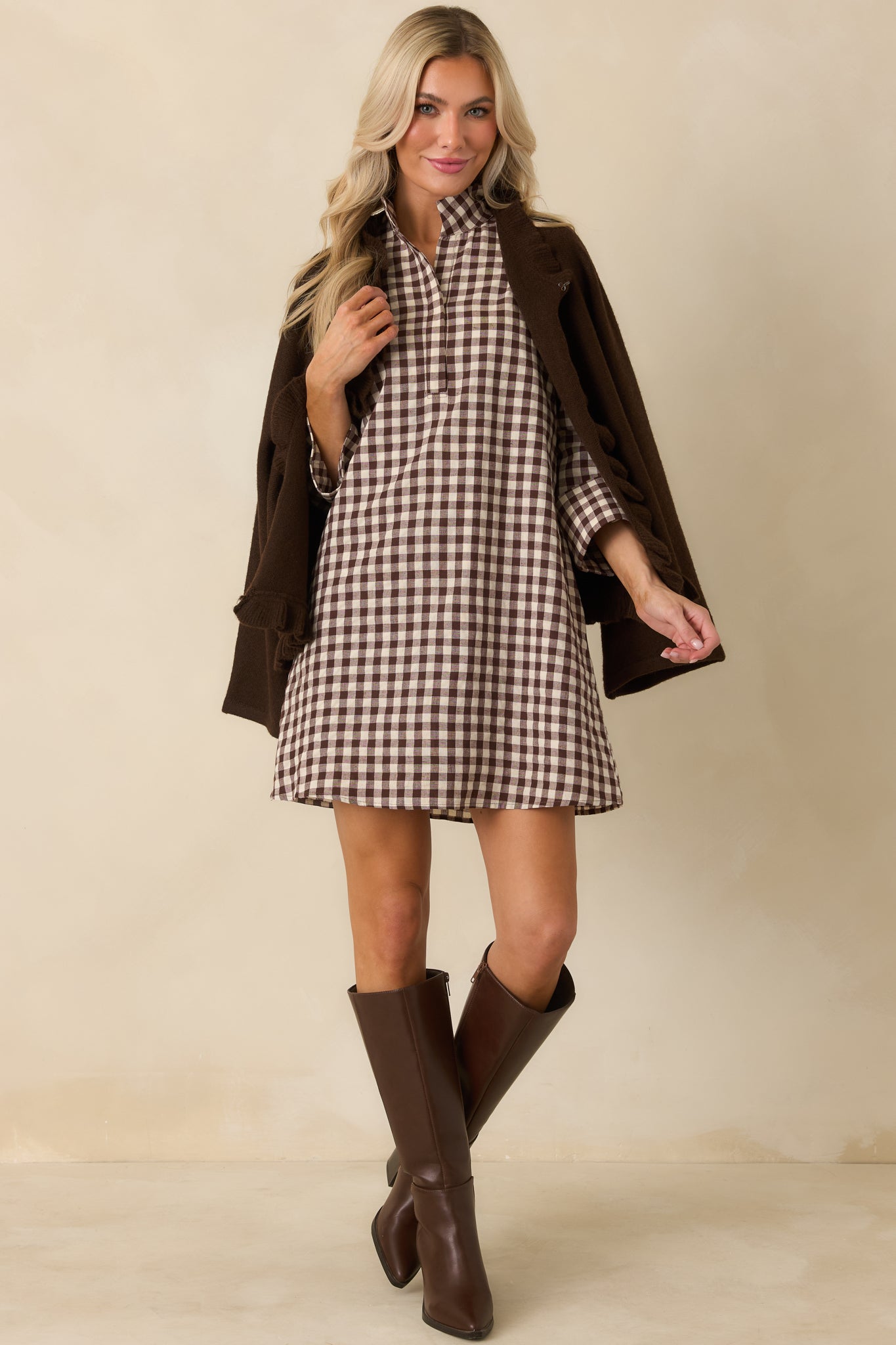 Chocolate brown and ivory gingham mini dress showcasing its clean tailored shape and structured stand collar.