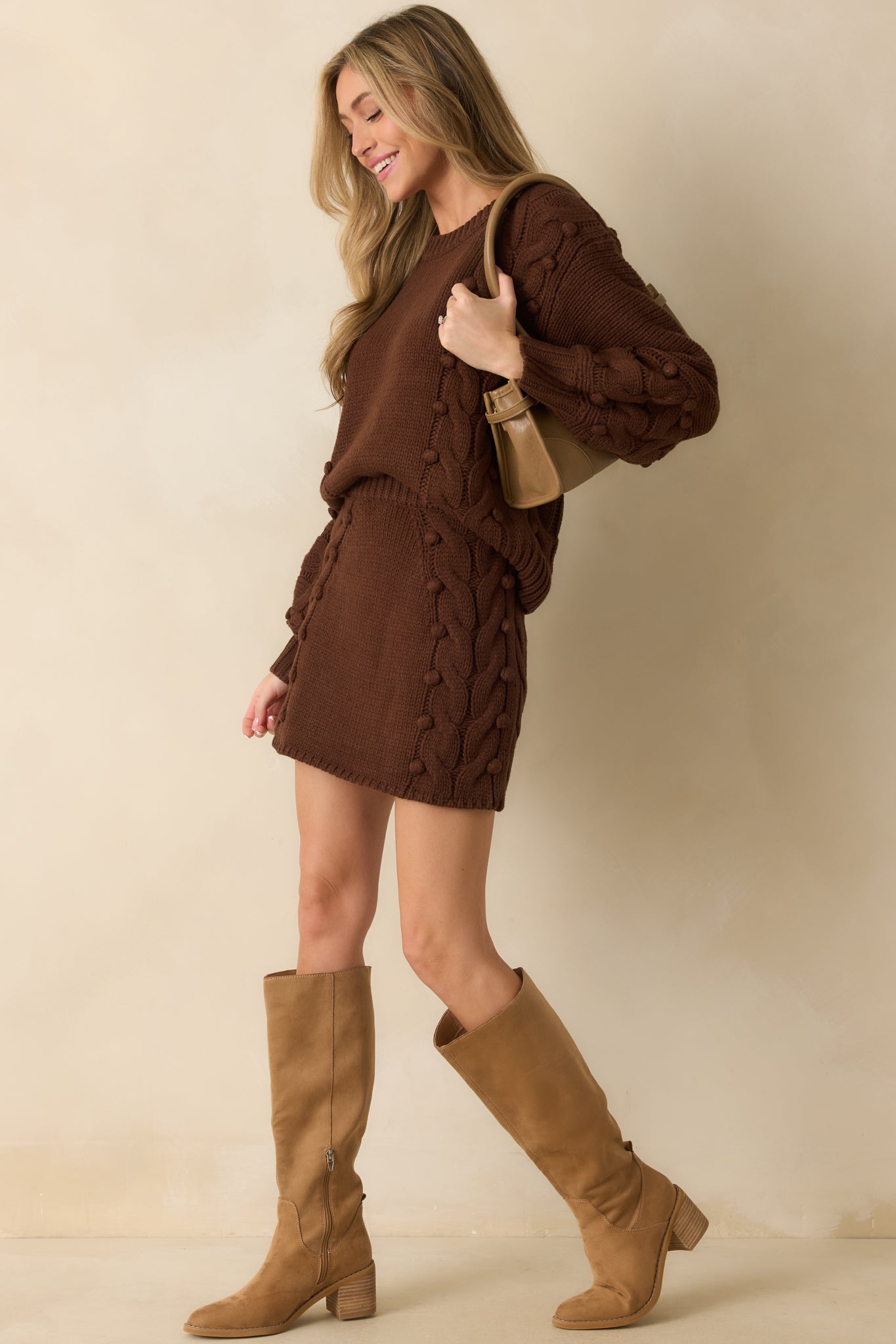 Knit mini skirt in rich chocolate brown with high-rise elastic waistband and textured cable knit throughout.