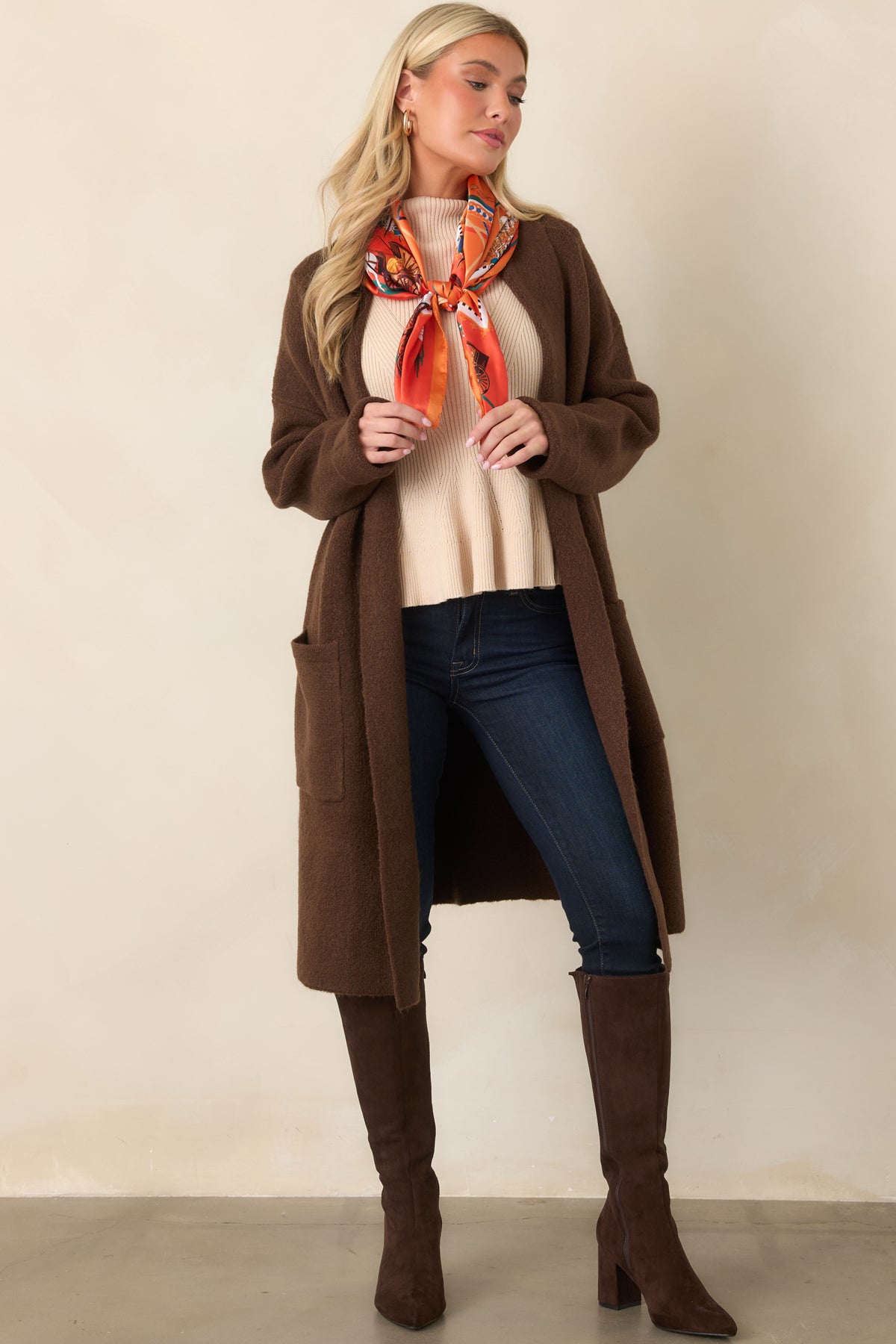 Rich chocolate brown knit cardigan with a relaxed silhouette, dropped shoulders, long sleeves, and a shawl collar.