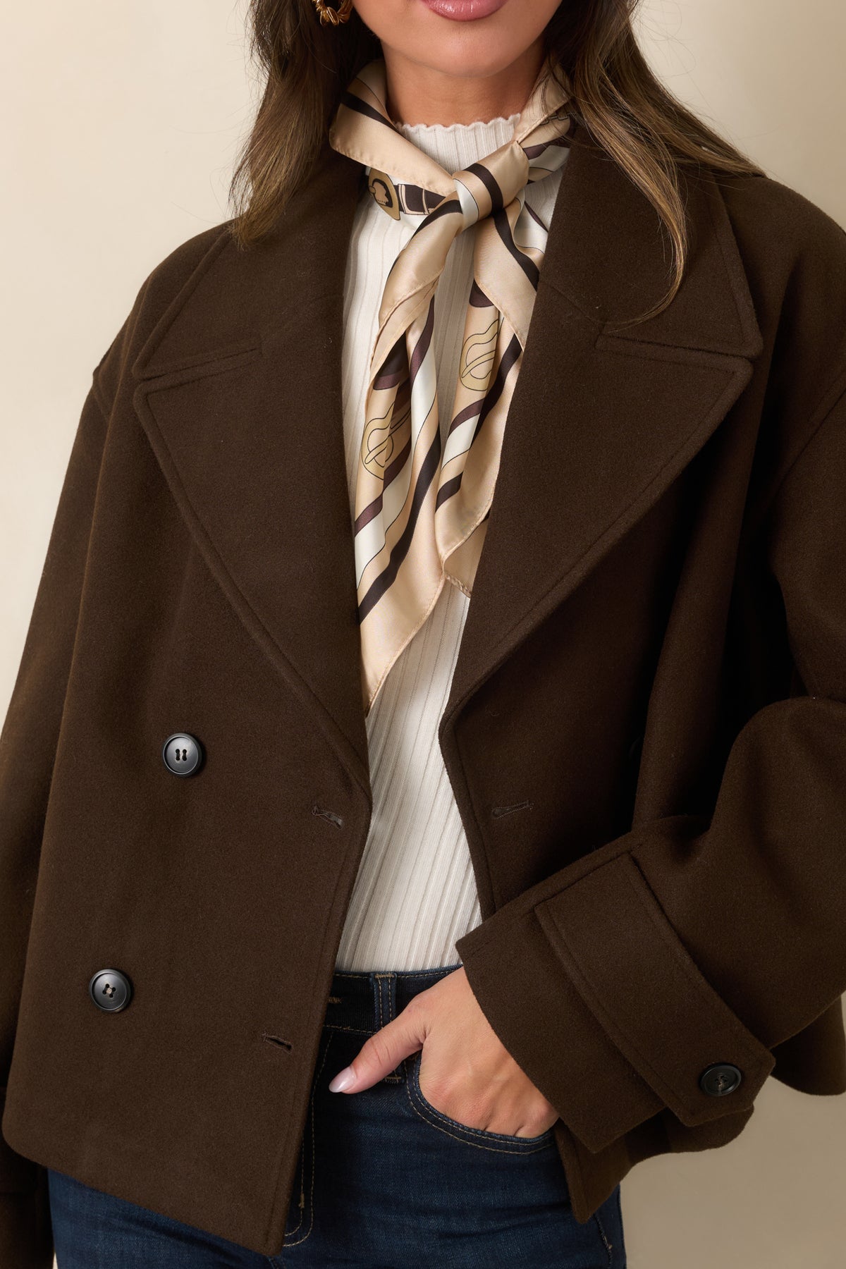 Chocolate brown jacket highlighting the oversized notched lapels and polished double-breasted button front.