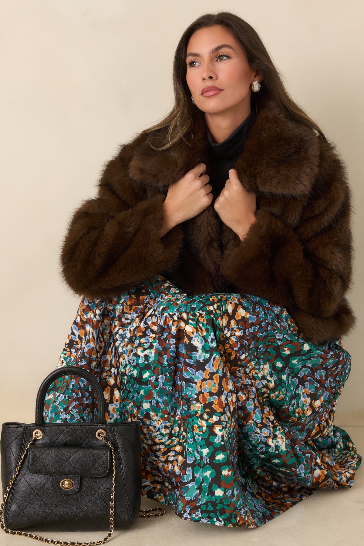 Plush chocolate brown faux fur jacket with three front hook closures and a soft structured shape.