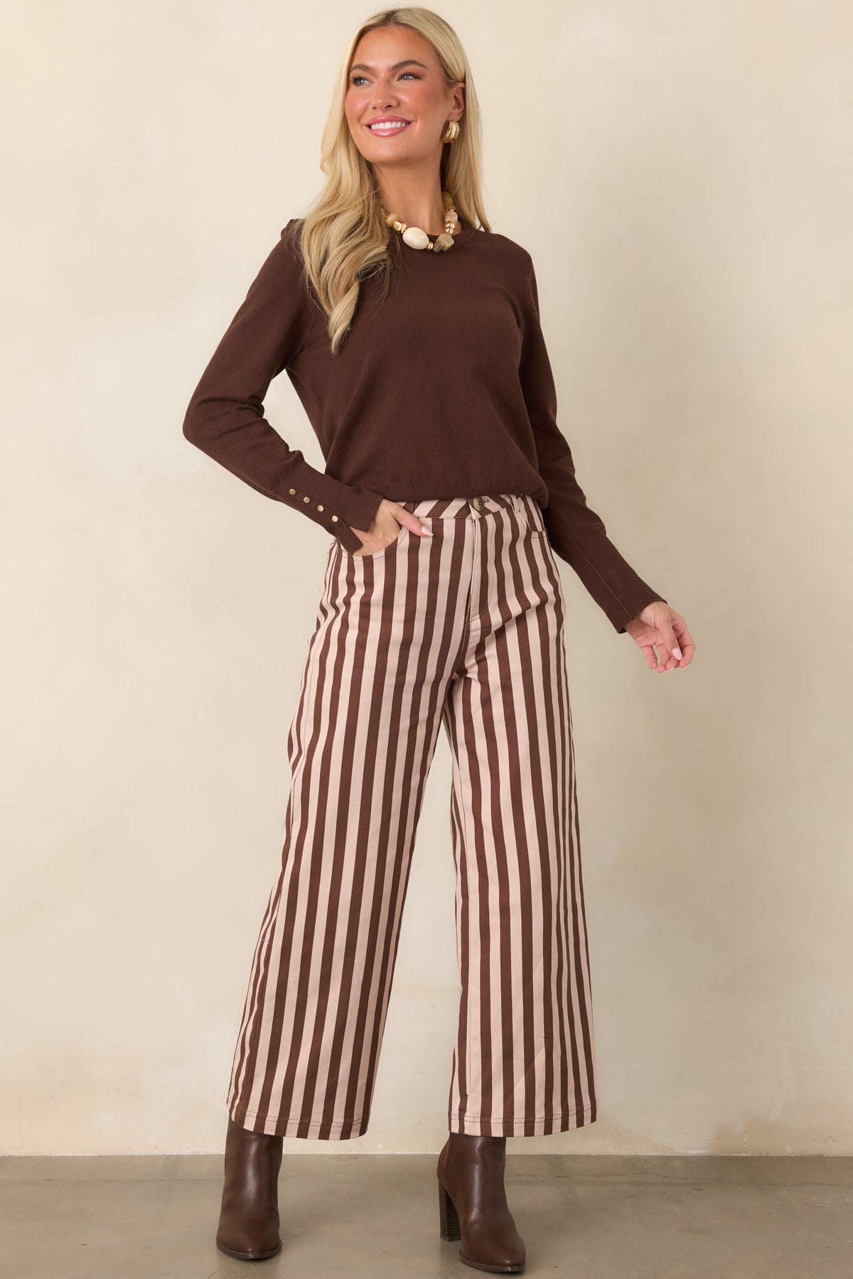 Rich chocolate brown top featuring a clean straight shape, classic crew neckline, long sleeves, and ribbed edges at the neckline and hem