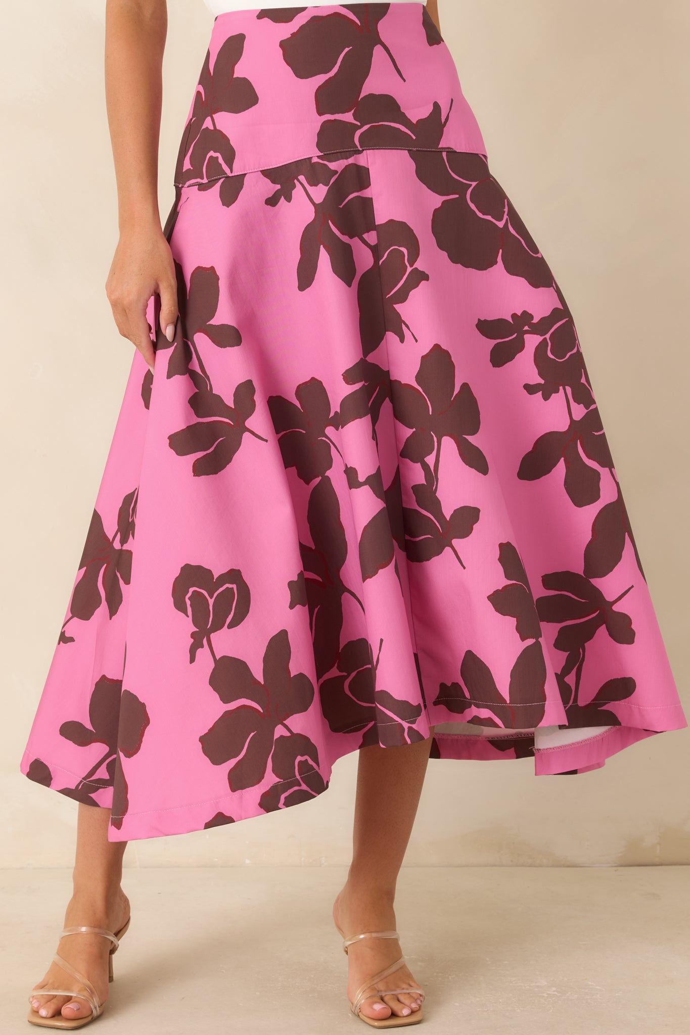Detailed view of the midi skirt showcasing the bold floral pattern, flowing A-line construction, and clean fitted waistband.