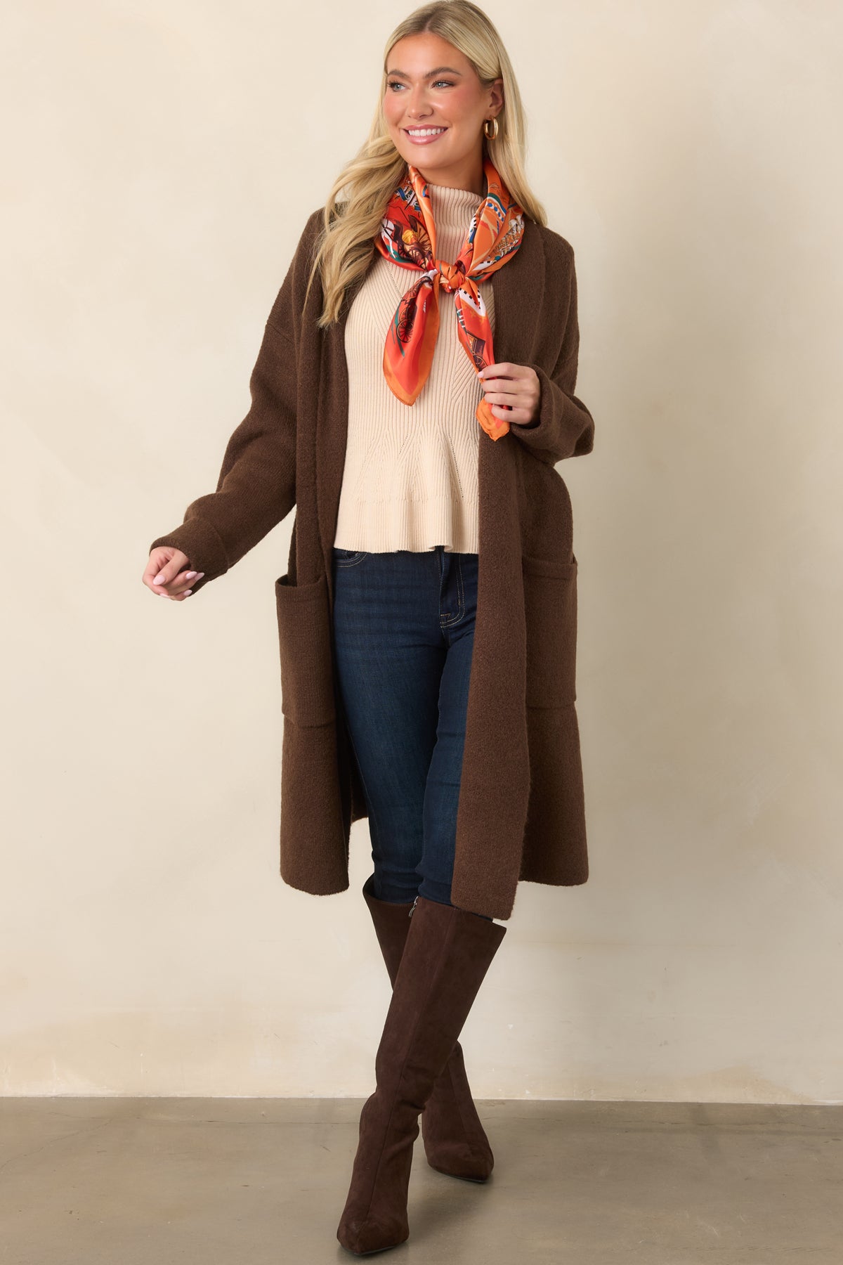 Open-front chocolate cardigan showcasing its wide shawl collar, dropped shoulders, and turned-back sleeve cuffs.