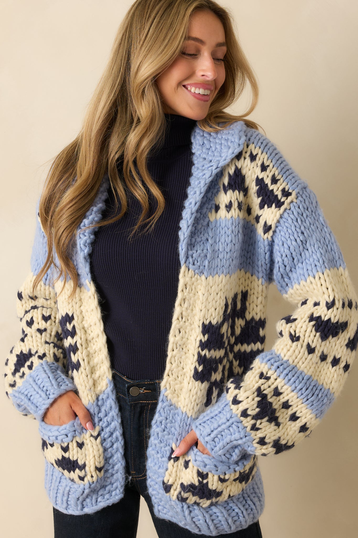 Detail view of knit texture and contrasting blue, cream, and navy blocks on the chunky cardigan.