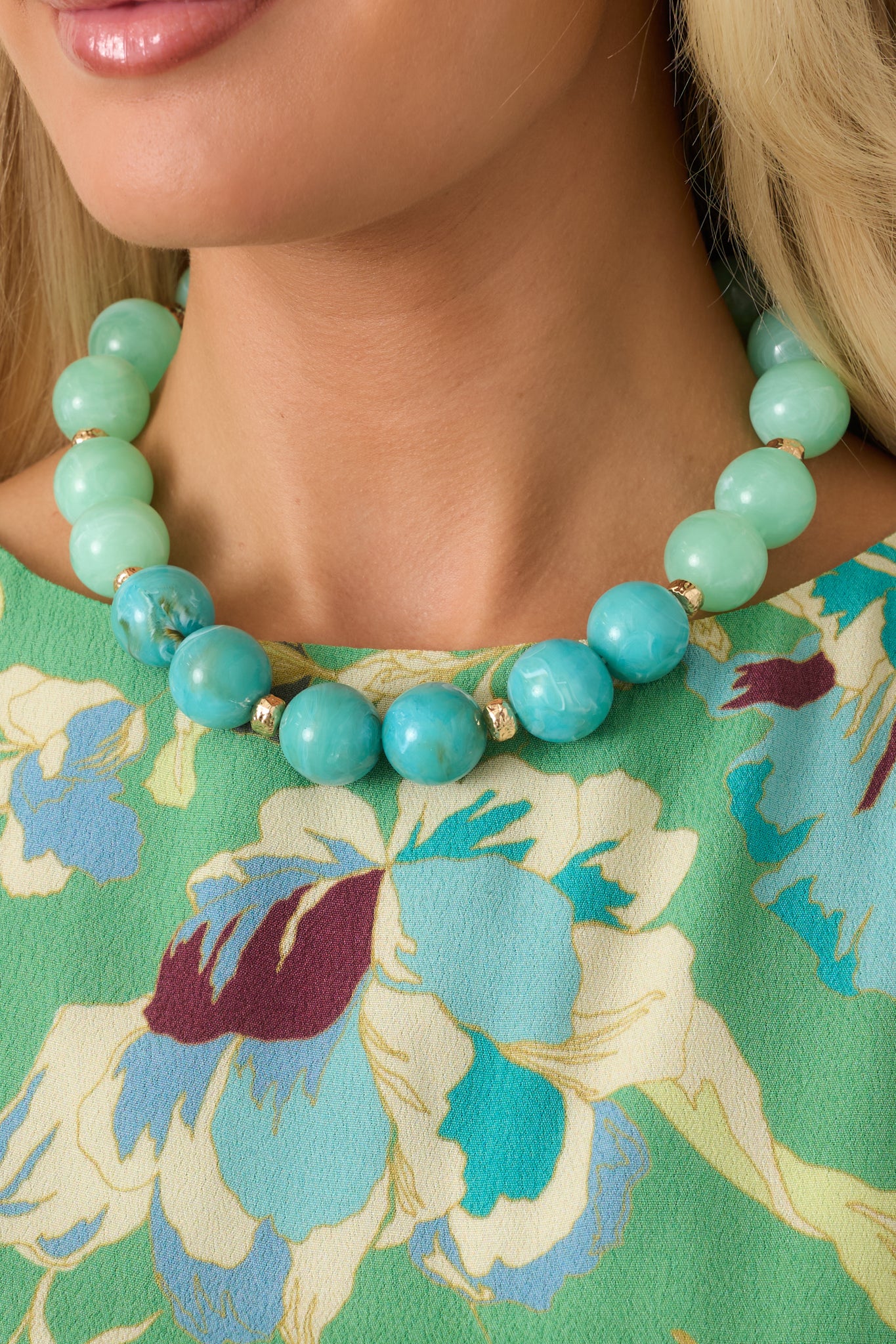 Chunky beaded necklace showcasing marbled mint and blue beads with elegant gold-tone detailing.