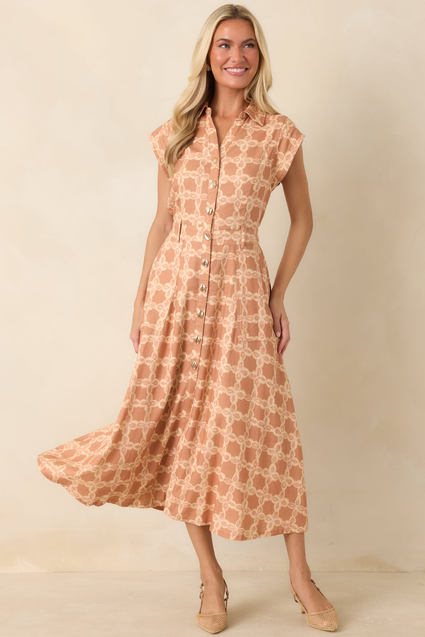 Classic button-front midi dress with a collared neckline, practical side pockets, and a polished everyday design.