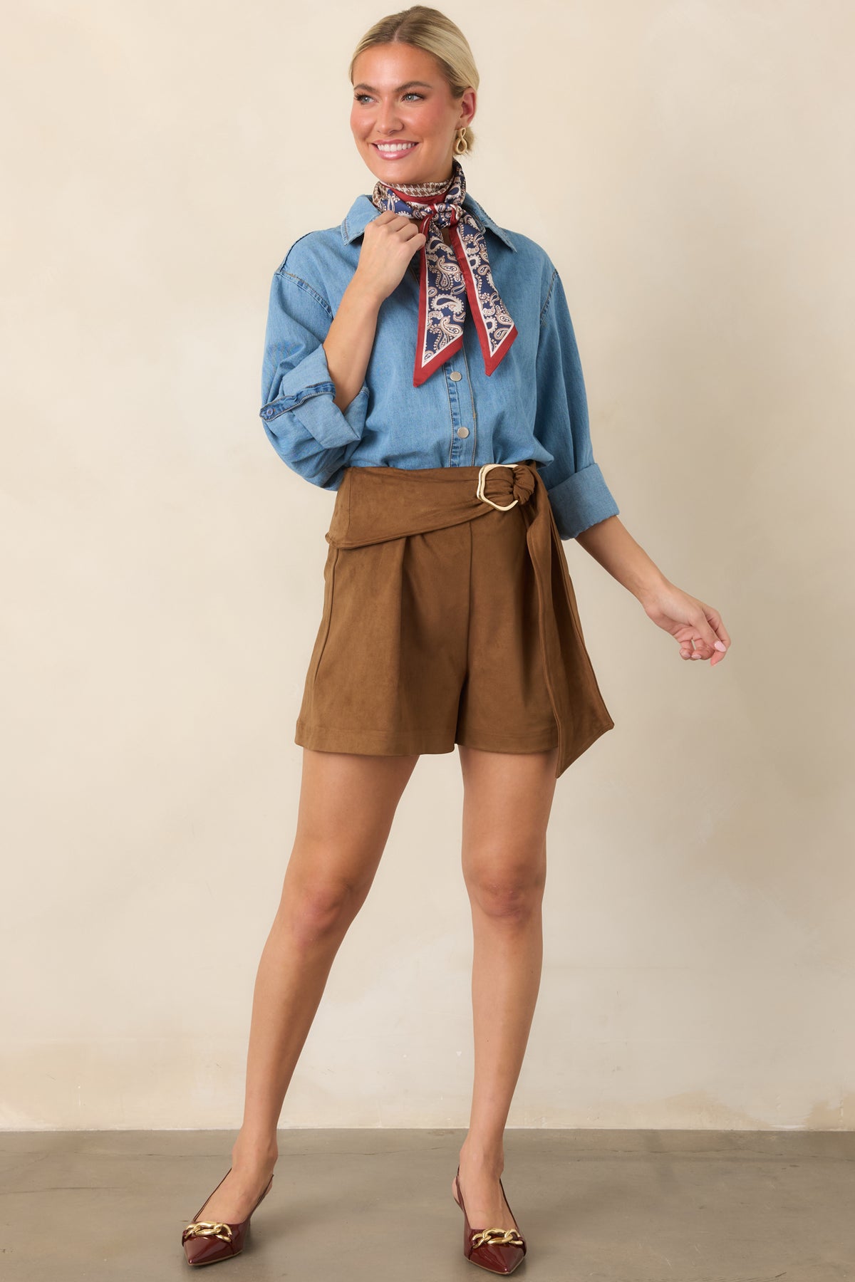Classic cotton button-front top with roll-tab sleeves and an asymmetrical high-low hem for added shape.