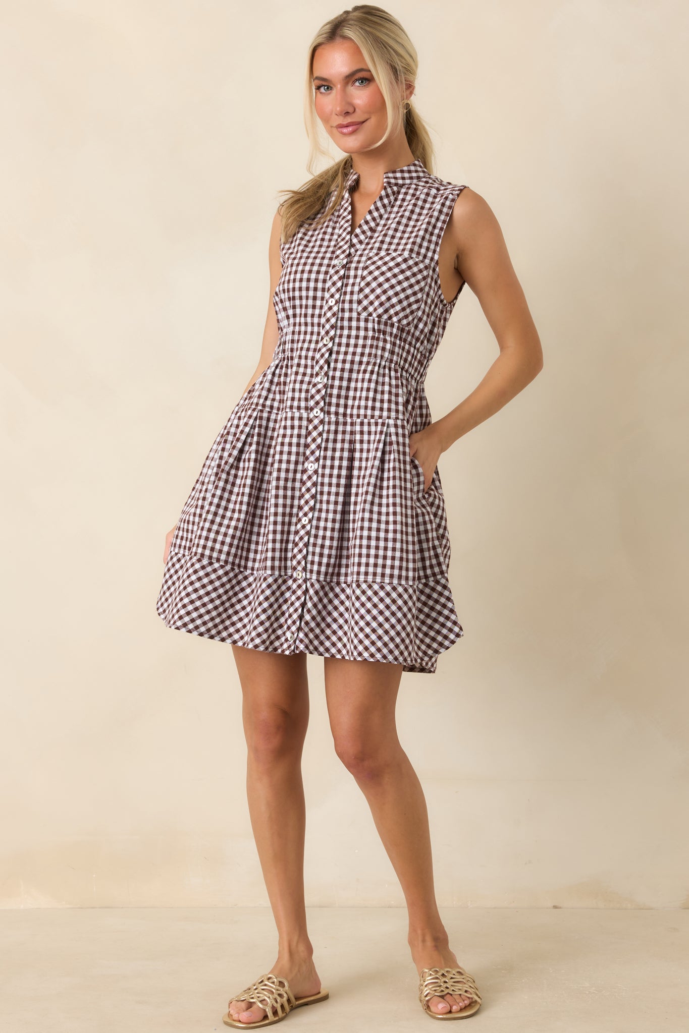 Classic gingham mini dress designed with a flattering elastic waist, chest pocket, and comfortable fully lined construction.
