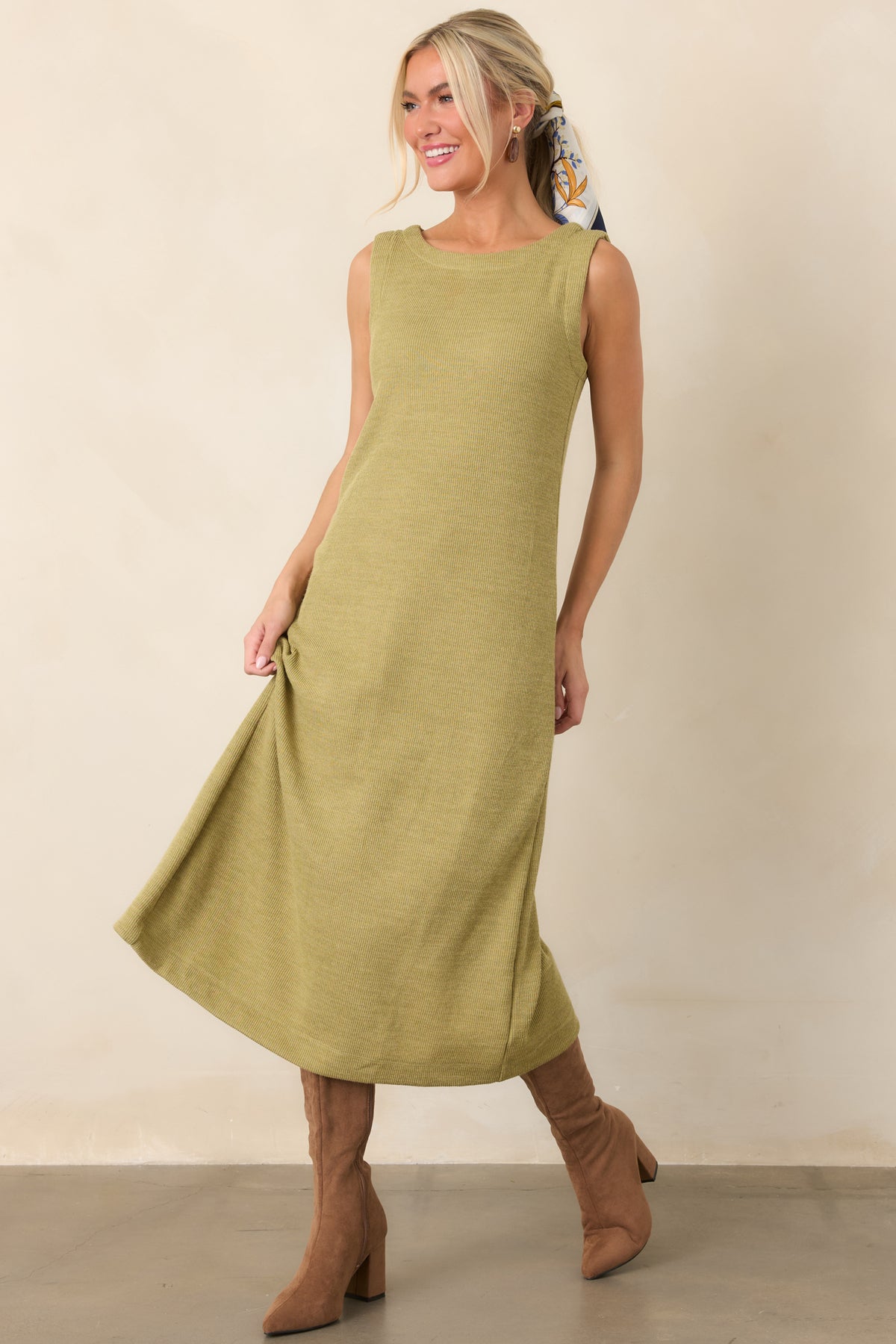 Classic olive midi dress combining a sleeveless cut, rounded neckline, and softly textured rib knit construction.