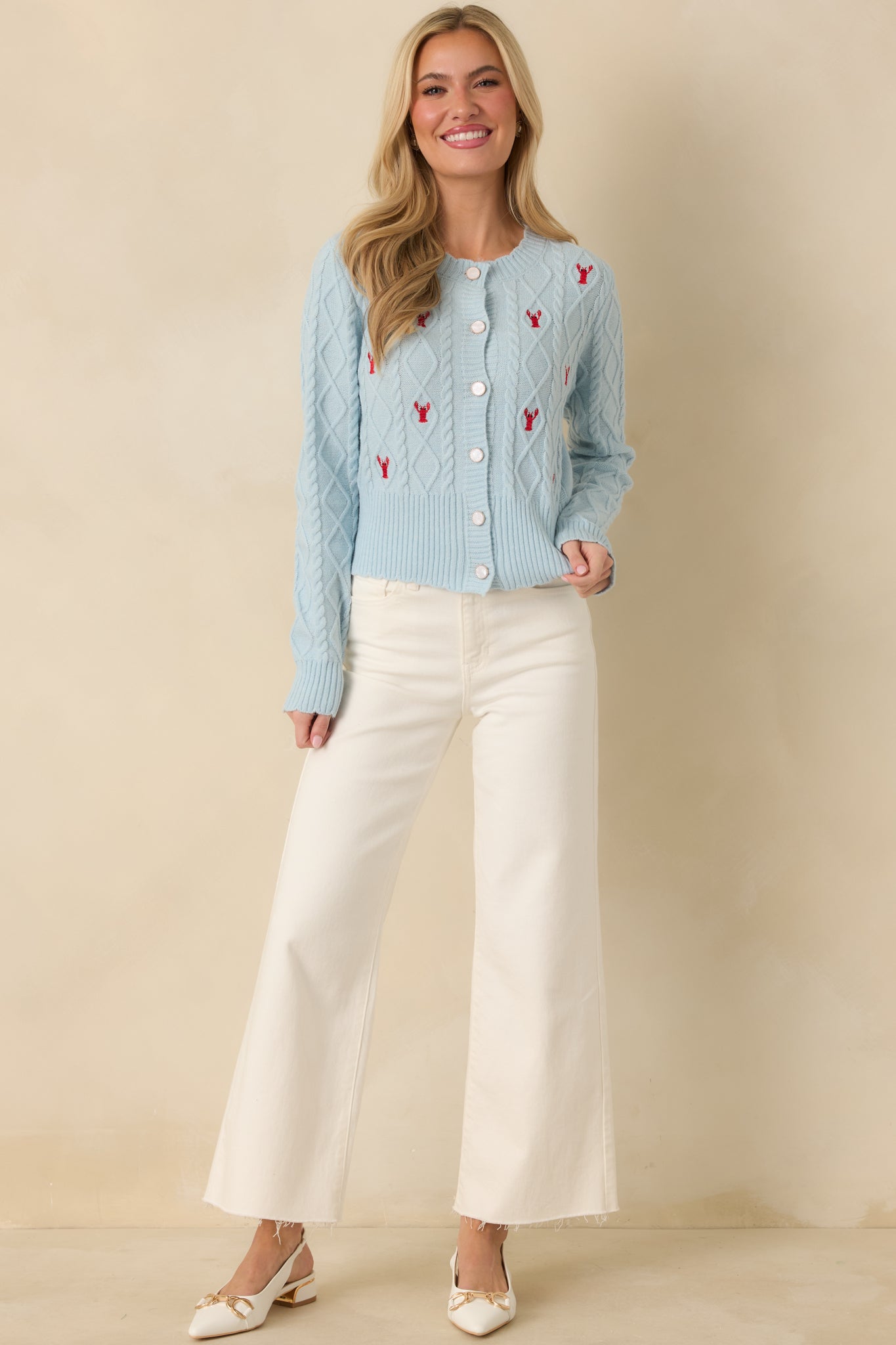 Classic round neckline cardigan with detailed lobster embroidery across the chest and torso.
