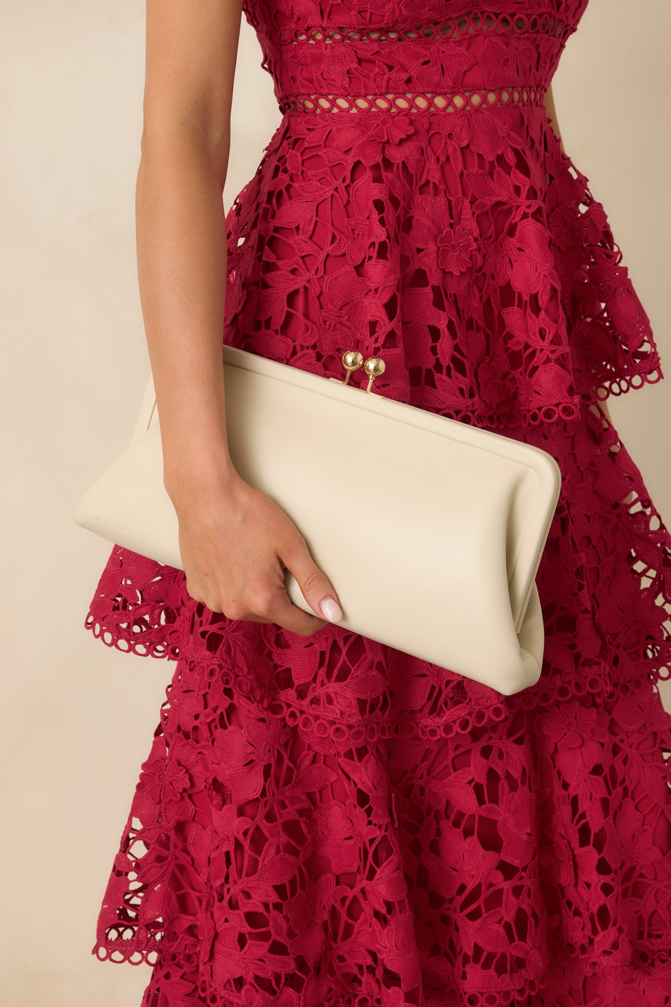Close crop emphasizing gold kiss-lock closure and textured faux leather surface.