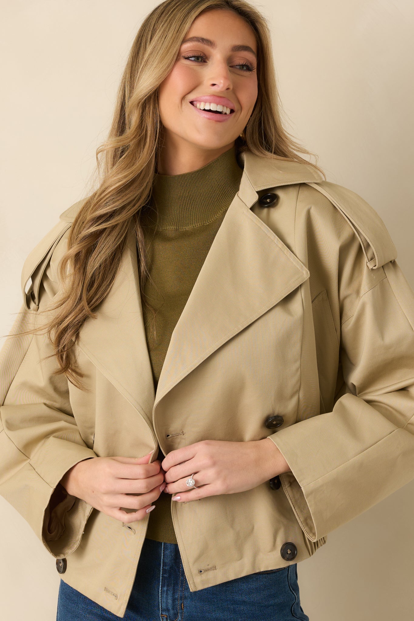 Close crop of sleeve and side seam showing buttoned cuff and cotton fabric texture.