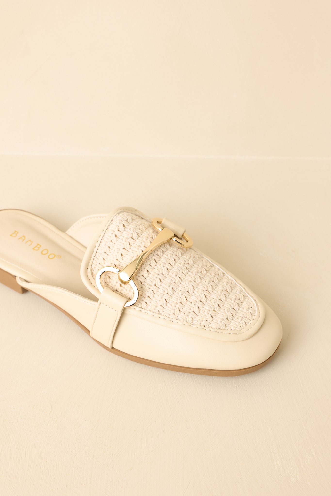 Close cropped angle highlighting the textured woven upper and sleek loafer shape.