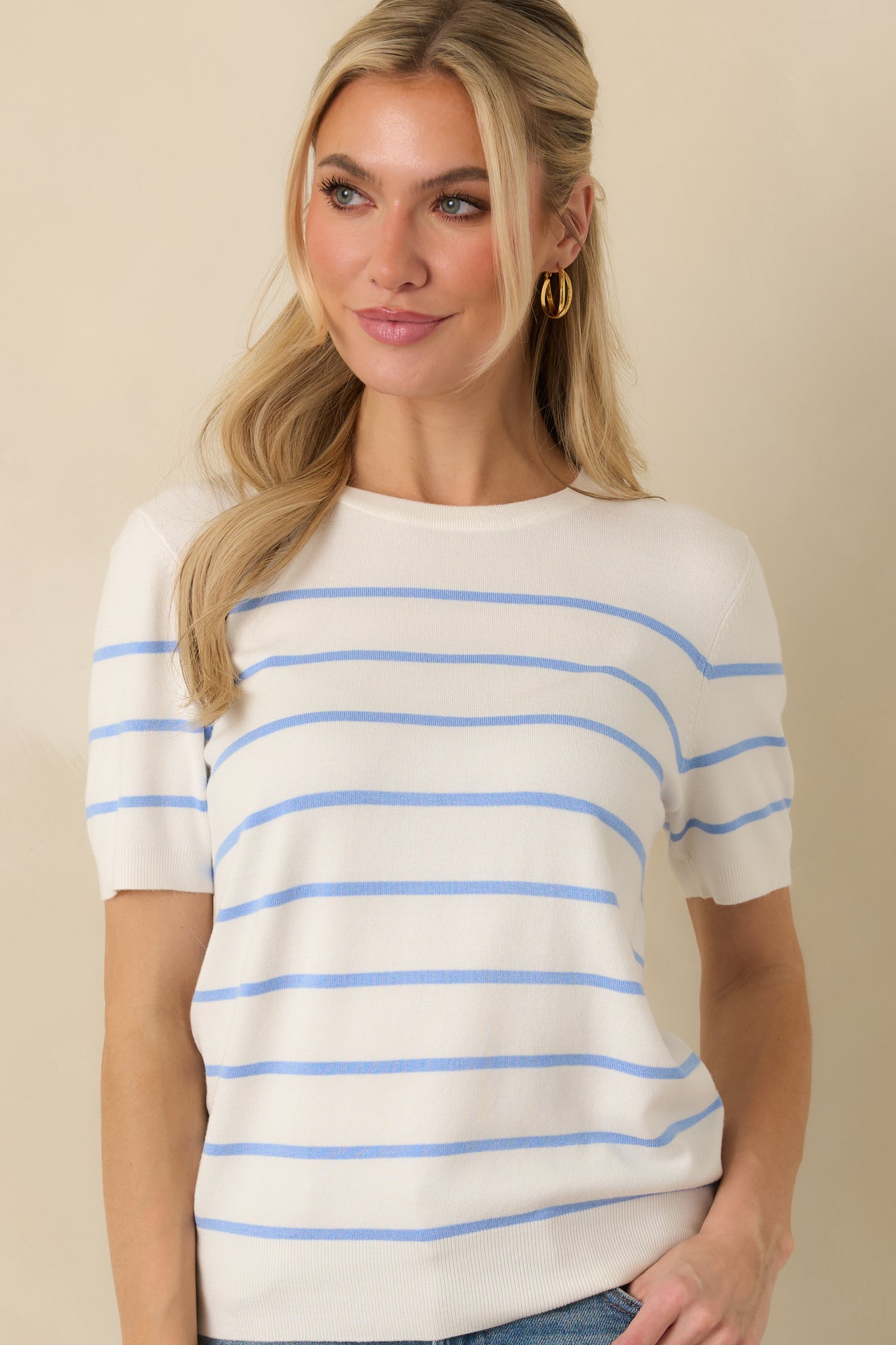 Close-cropped image emphasizing the ribbed trim along the sleeves and hem.