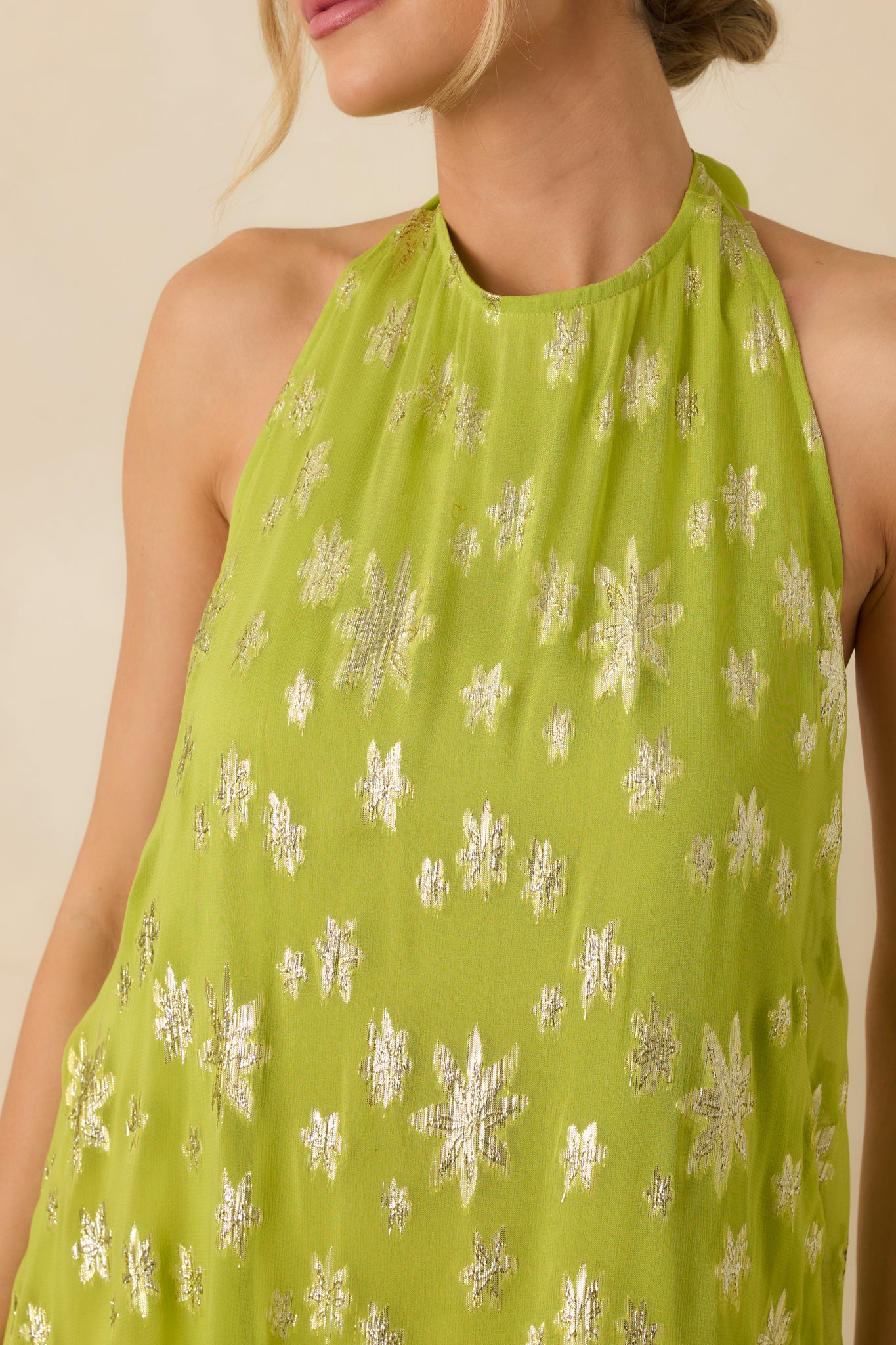 Close detail of the lightweight chartreuse woven fabric highlighting metallic floral detailing and subtle sheen.