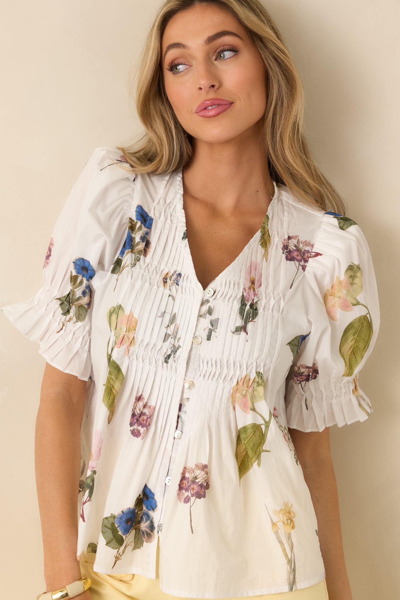 Close focus on the front pintucks, adding dimension and light structure to the flowy cotton.