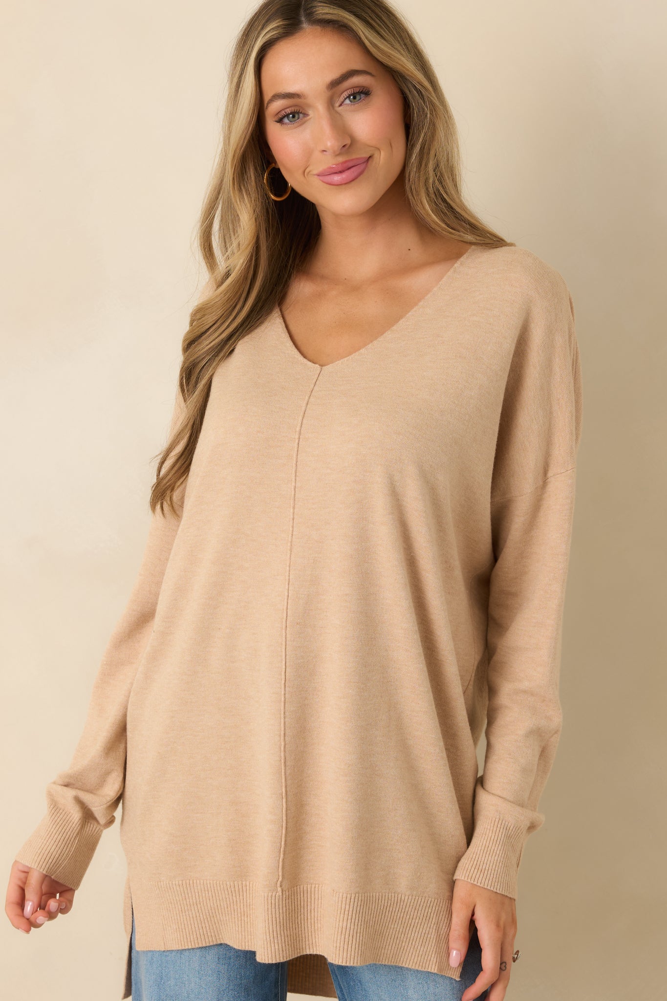 Close framing on the side slit with visible drape and texture of the knit.