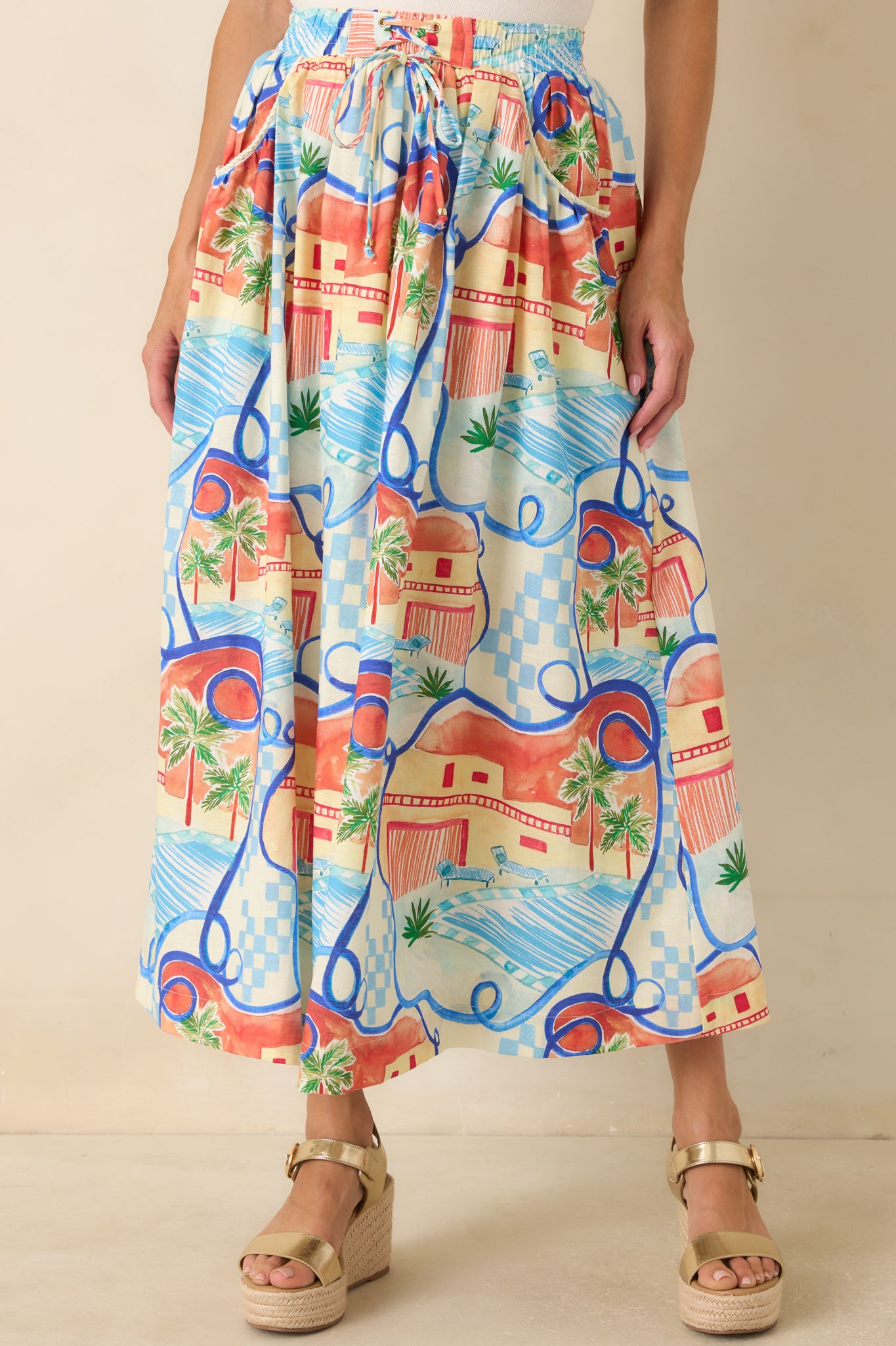 Close look at the elastic waistband, adjustable drawstring tie, and lightweight fabric of the printed skirt.