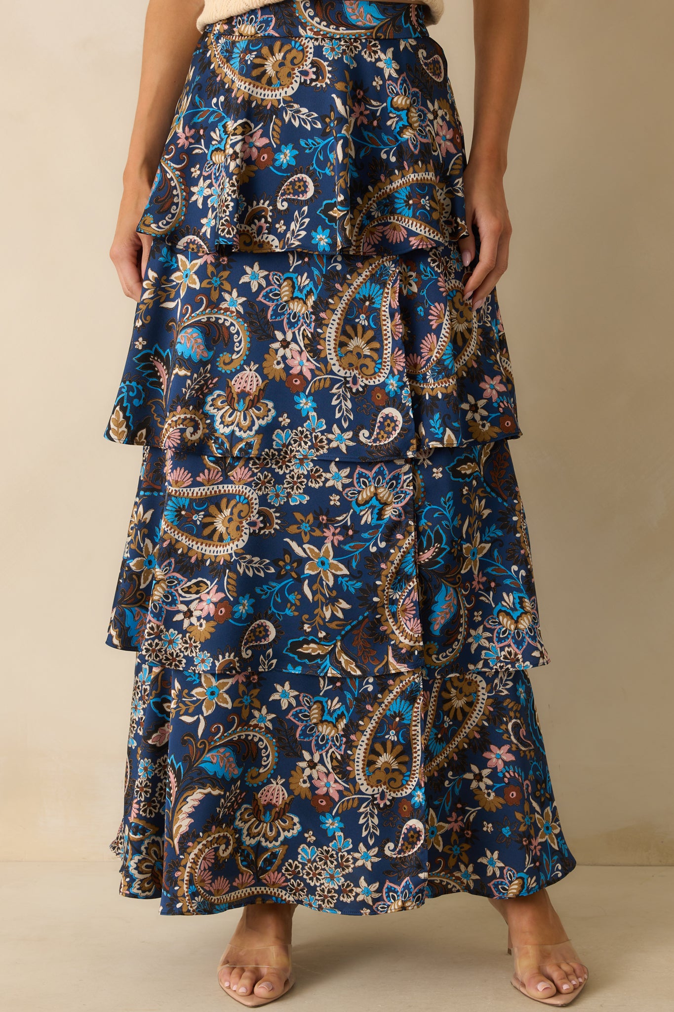 Close look at the tiered construction and side slit detail of the navy skirt.