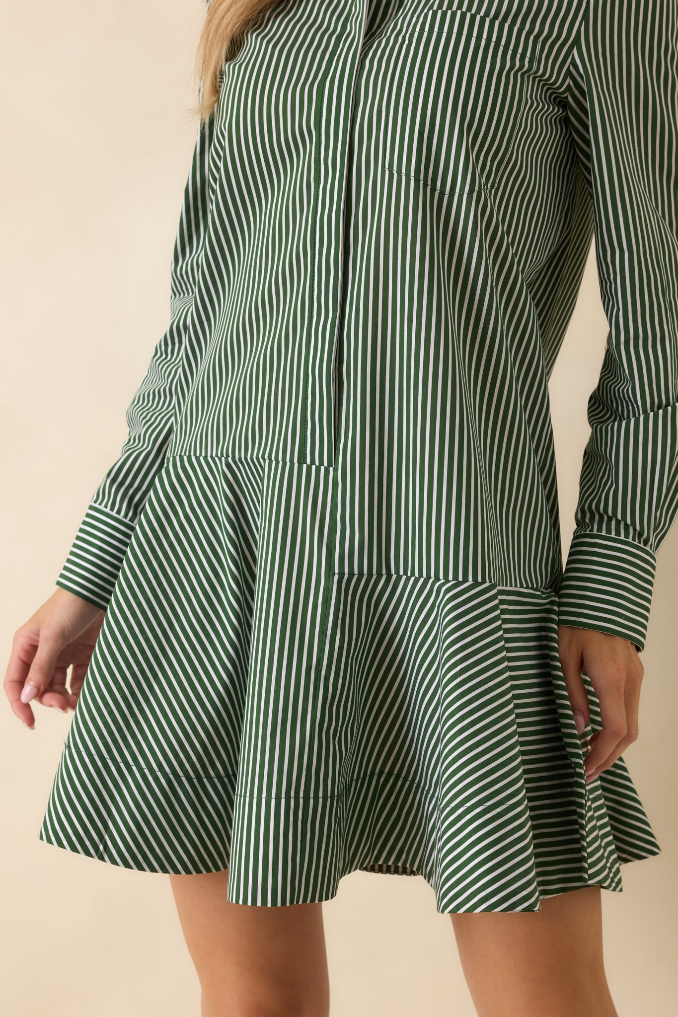 Close-up of the buttoned cuff detail highlighting the crisp construction and stripe alignment.