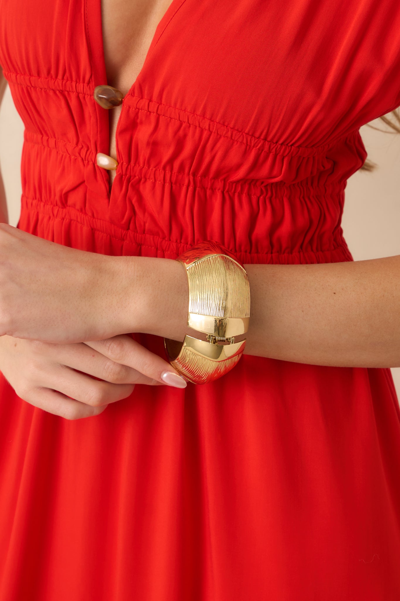 Close-up detail of the bracelet’s engraved linear texture panels and the polished finish along the cuff.