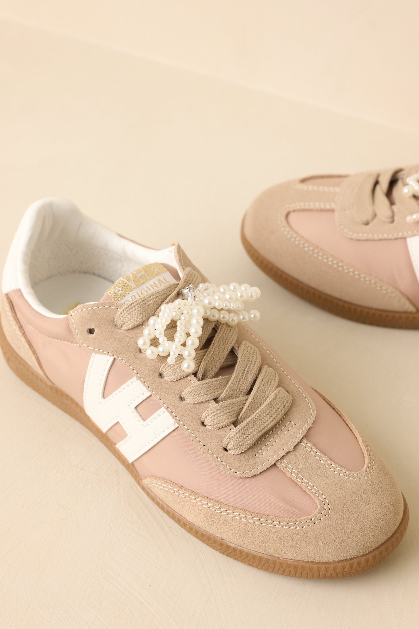 Close-up detail of the removable pearl bow accent, showcasing its decorative and elevated look.