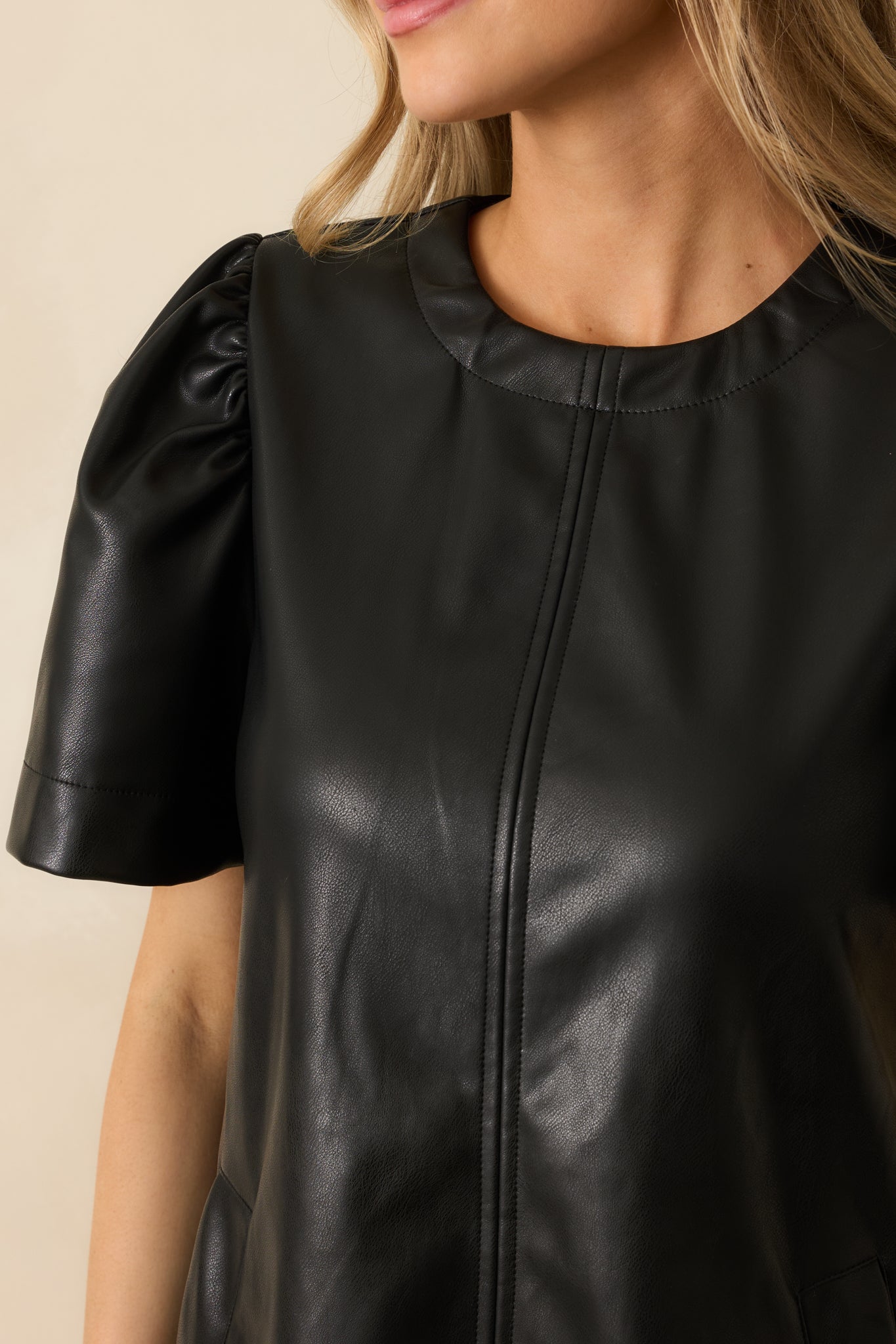 Close-up of the faux leather material displaying its soft sheen and refined seamwork.